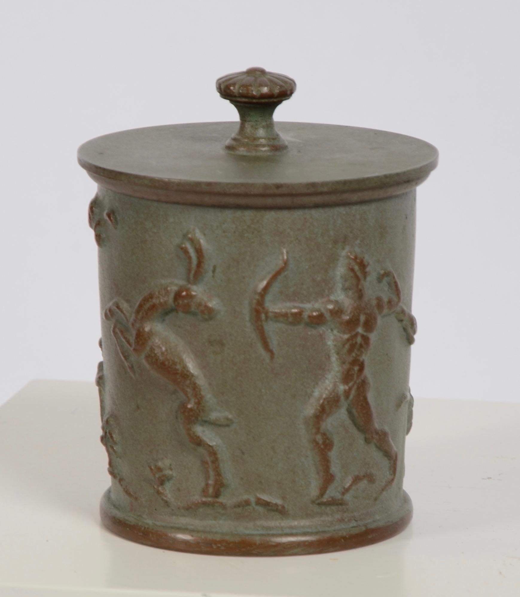 A Swedish Grace cast iron tobacco jar with relief hunting scenery. Designed by Carl Elmberg for Näfveqvarns Bruk, 1920s.