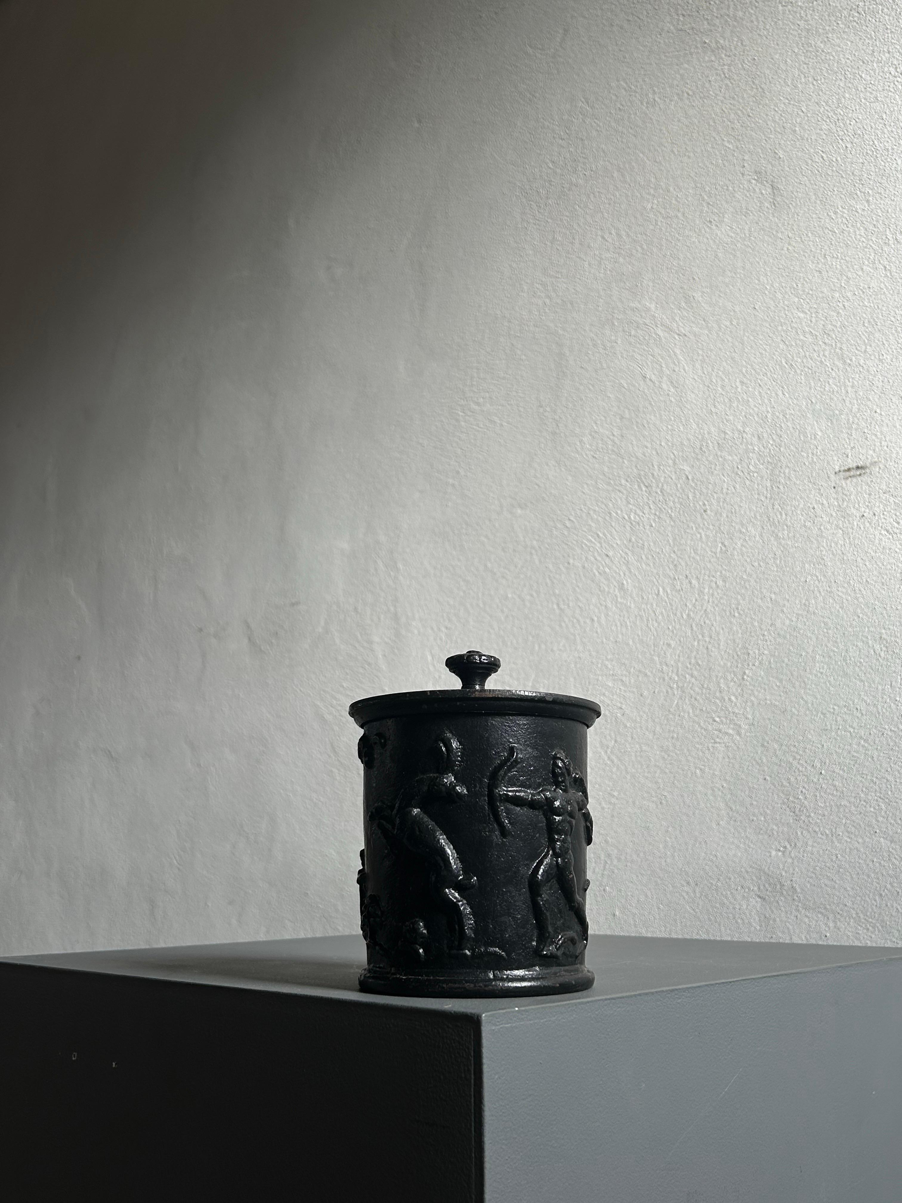 A rare and exquisite lidded jar in cast iron designed by Swedish sculptor Carl Elmberg and produced by Näfveqvarns Bruk in the 1920s. This collectible piece embodies the refined artistry and craftsmanship synonymous with Scandinavian design of the