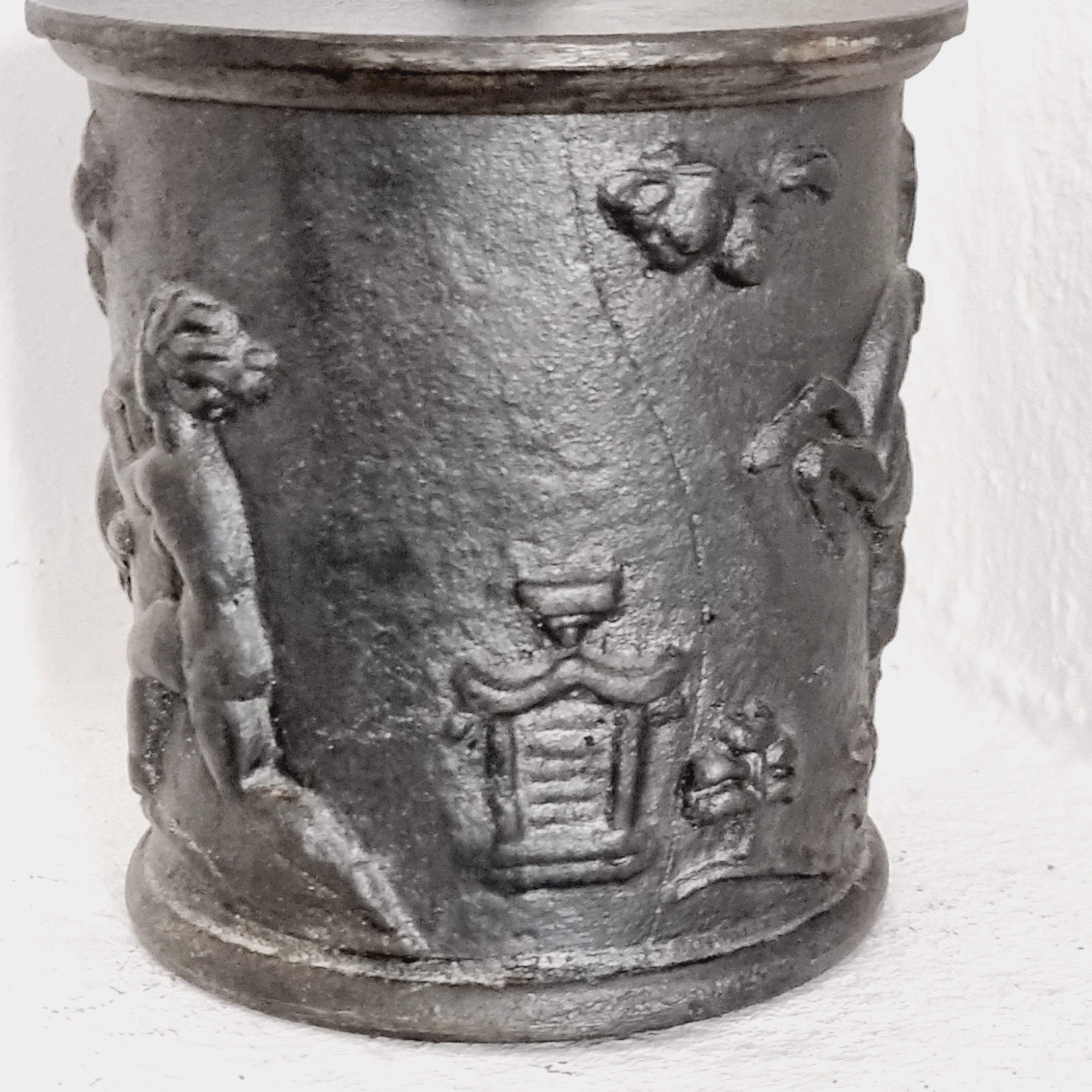 Decorative tobacco jar in cast iron with decor of animals and figures. Designed by Carl Elmberg for Näfveqvarns bruk, Swedish Grace, 1920s. 

Carl Elmberg (1889–1955) sculptor and craftsman. Worked after his studies in Germany and Italy with the