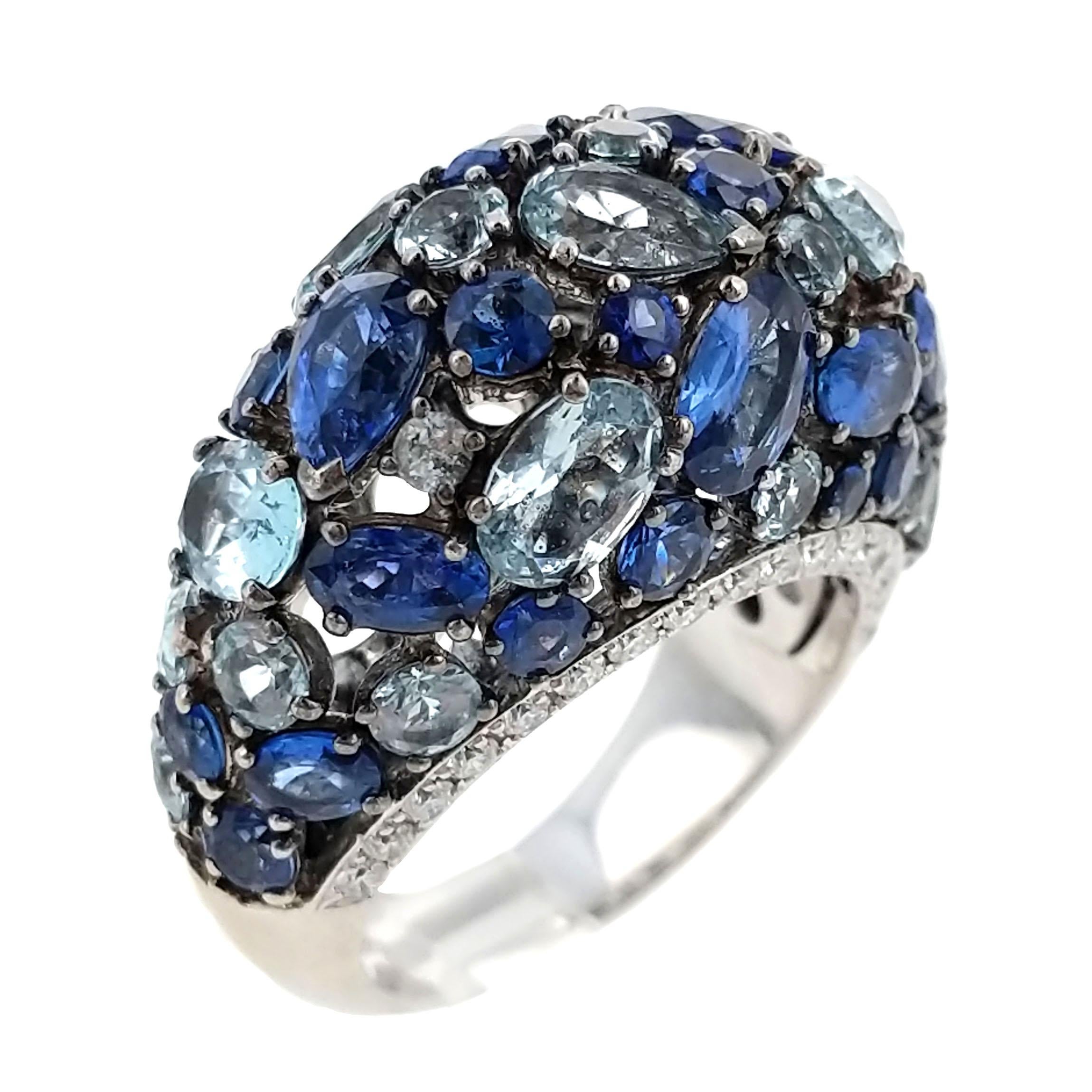 A bombé ring set openwork with oval- and round-shaped sapphires and pear-shaped light blue topazes bordered by brilliant-cut diamonds, mounted in 18k white gold. Stamped CB for Carl Bucherer, Swiss. Size 7.25.

* More photos by request
* FREE