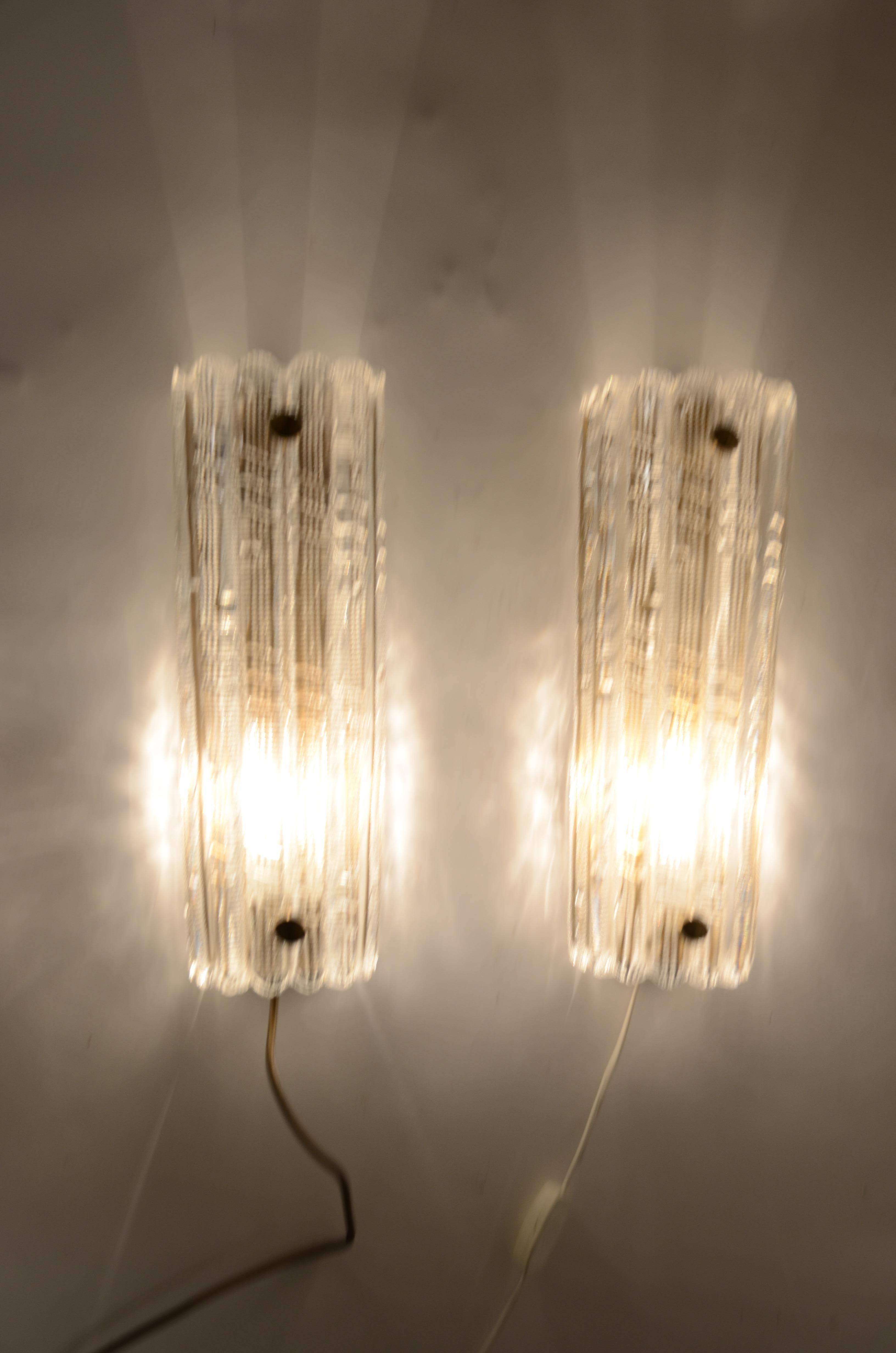 A pair of large wall lights designed by Carl Fagerlund for Orrefors. Sweden 1960s. Glass on brass plate with one socket in each fixture.