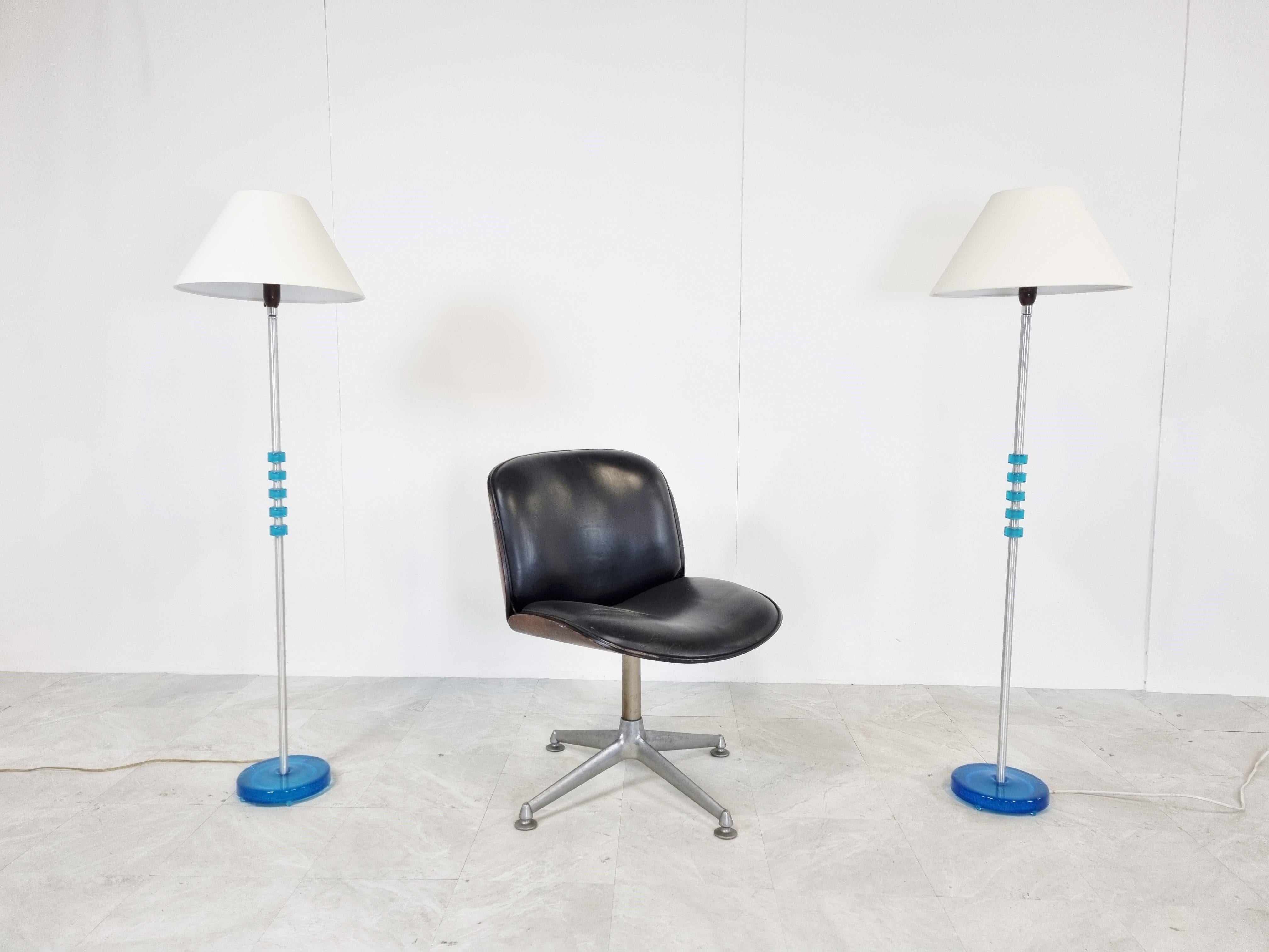 Mid-century swedish blue glass floor lamps designed by Carl Fagerlund and produced by Orrefors.

Striking blue coloured glass with a brushed metal rod and the original bakeliste sockets with switches.

Elegant floor lamps which stand strong as a