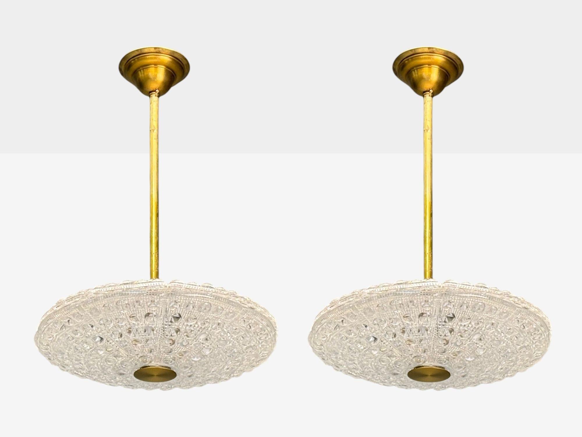 Carl Fagerlund, Swedish Mid-Century Modern, Brass, Glass, Pendant Lights, Sweden, 1940s

Pair of 'UFO' pendant lights designed and produced by Carl Fagerlund for Orrefors in Sweden c. 1940s. Each example has six lights and two unique saucer form