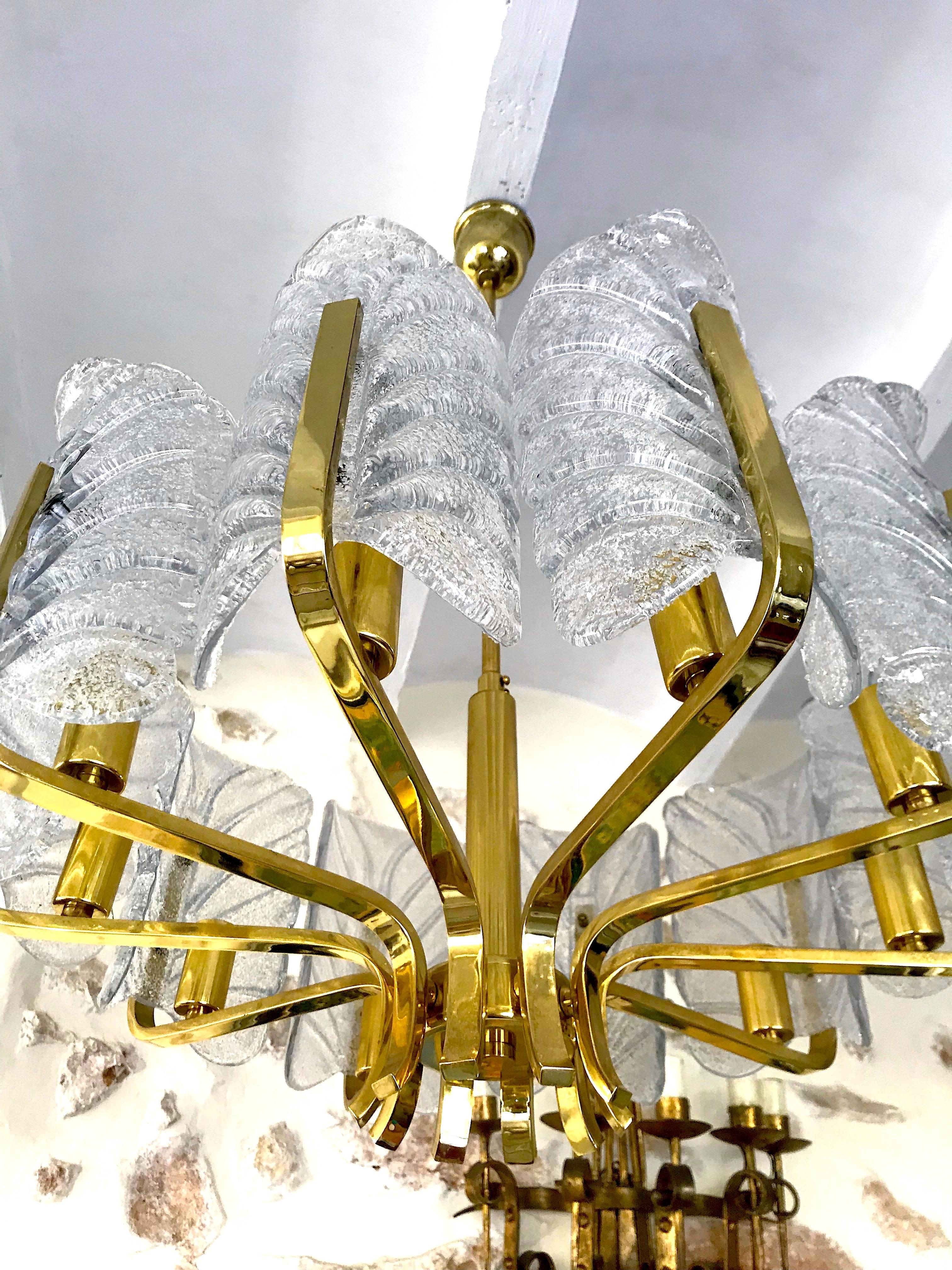 This beautifully and stunning large pendant chandelier with ten glass shades and brass fittings was produced in the 1960s by the iconic firm of Orrefors and designed by Carl Fagerlund. Beautifully carved clear frosted glass shades in a leaf design