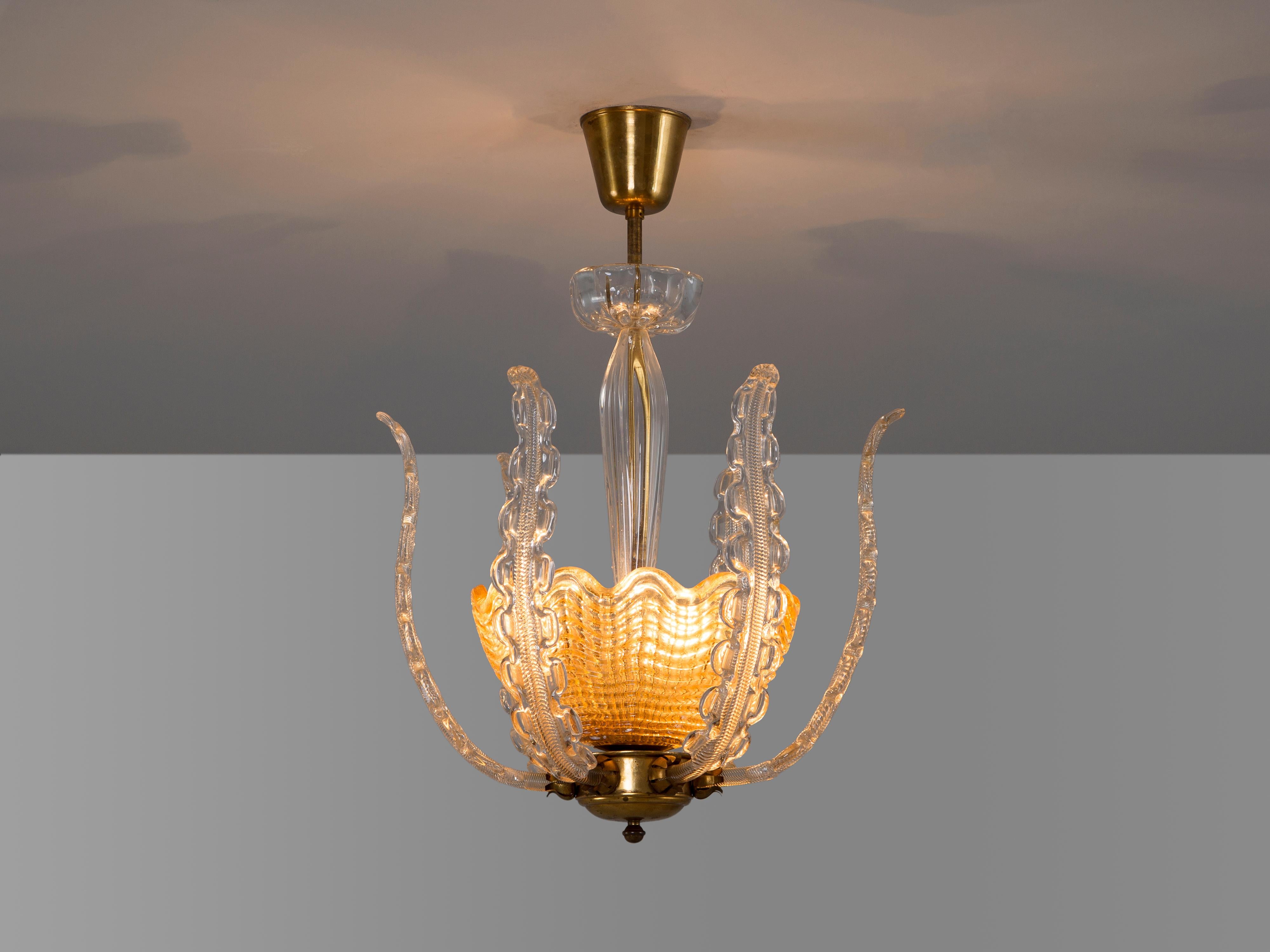 Chandelier, in brass and glass, by Carl Fagerlund for Orrefors, Sweden, 1940s.

Royal chandelier in structured glass and brass. The light consist of a structured glass bowl with six long glass leaves or 'tentacles'. The combination of the brass