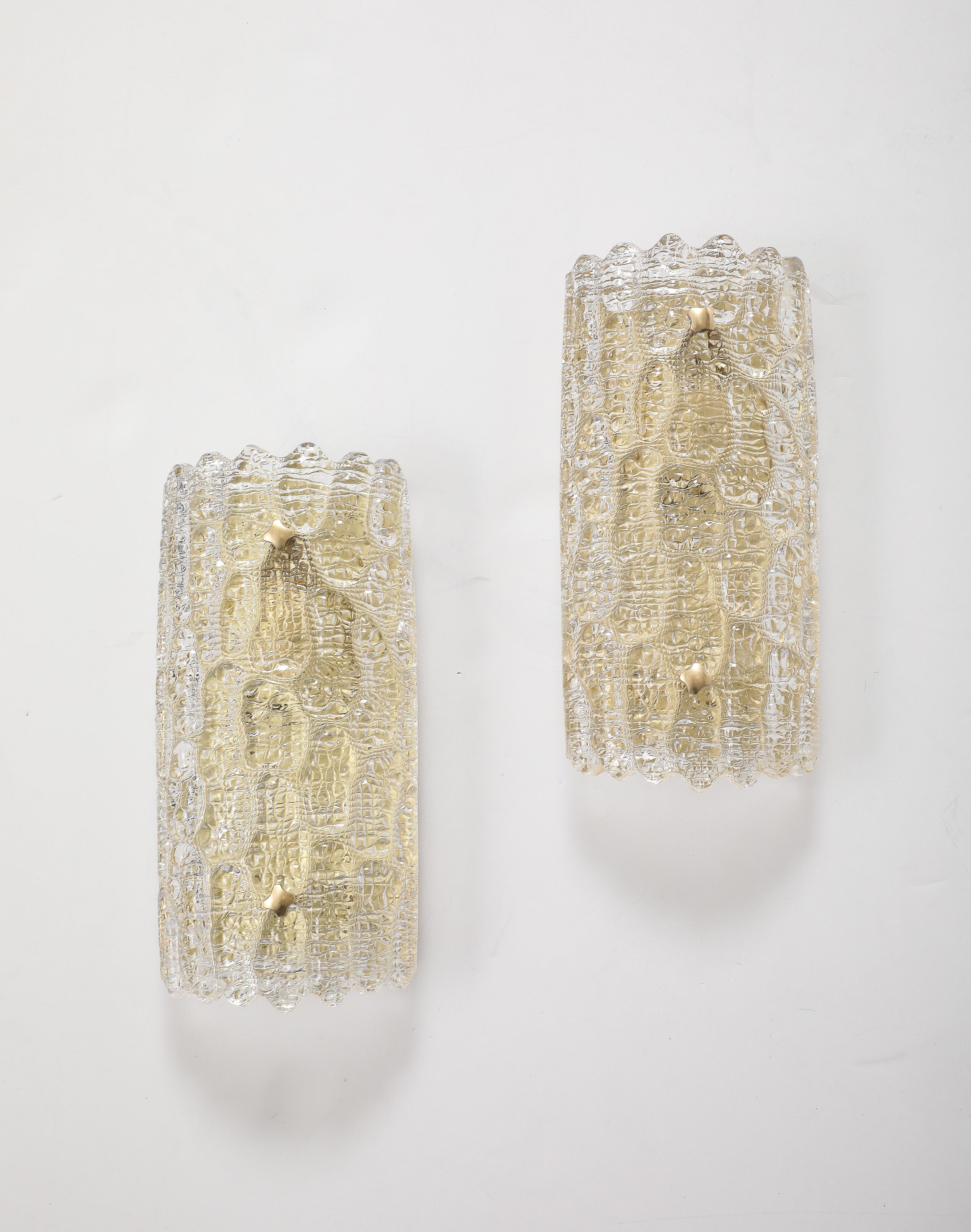 Pareja de apliques de cristal de los años 60, de Carl Fagerlund para Orrefors.
El cristal de bella textura se asienta sobre una placa posterior de latón pulido con un único 
enchufe de luz candelabro recién recableado para EE.UU. con un  60 vatios