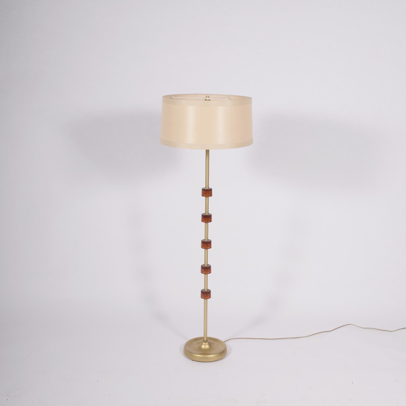 Brass glass wood this combination of floor lamp design by Carl Fagerlund new shade.