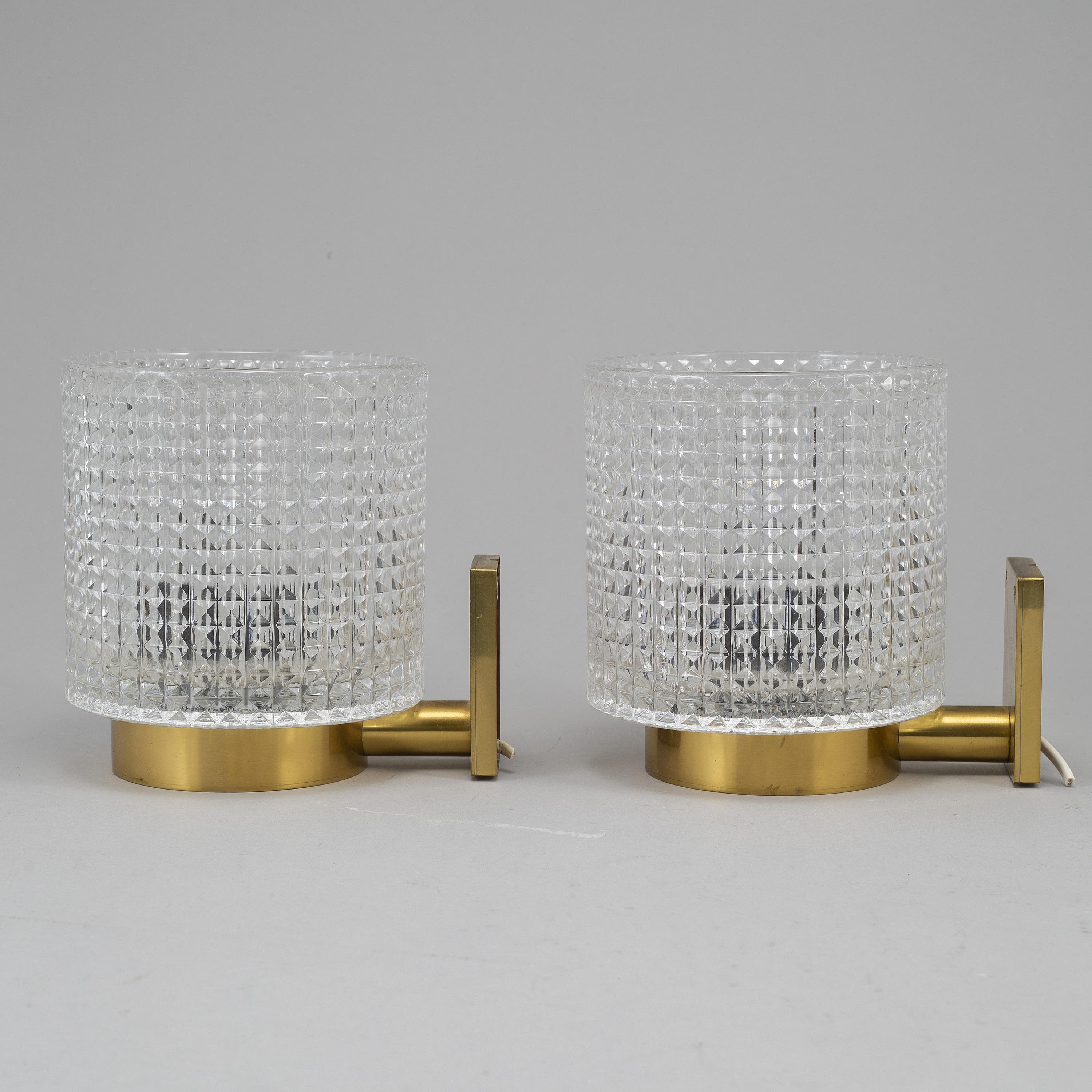 very elegant pair of sconces by carl Fagerlund for Orrefors, brass with diamond cut glass good condition, electrical has not been tested.