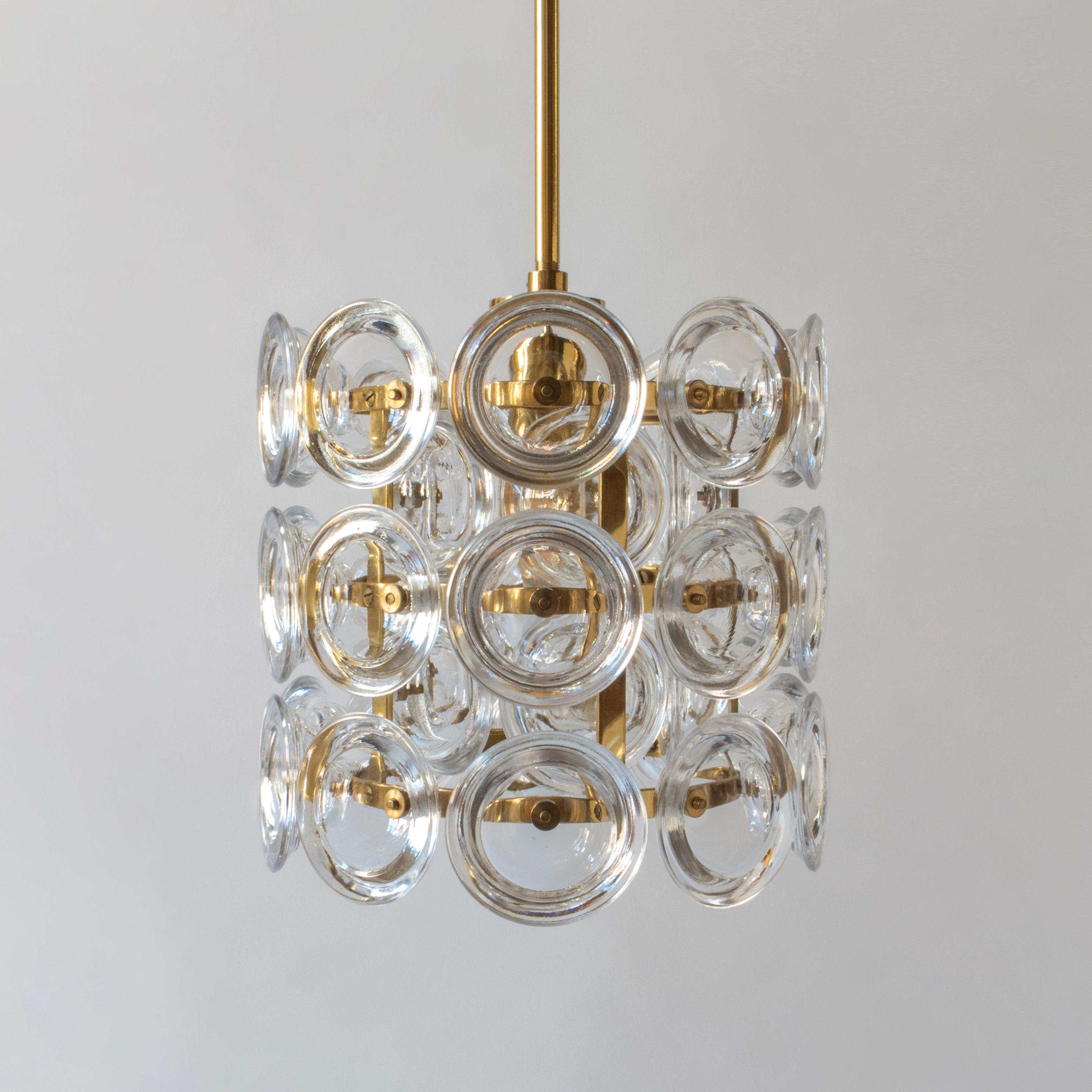 Each pendant composed of forty glass discs, fastened internally and externally to a brass frame, concealing a single e26 base light holder. Ready to add to your collection; each in beautiful condition, rewired and professionally restored. Height is