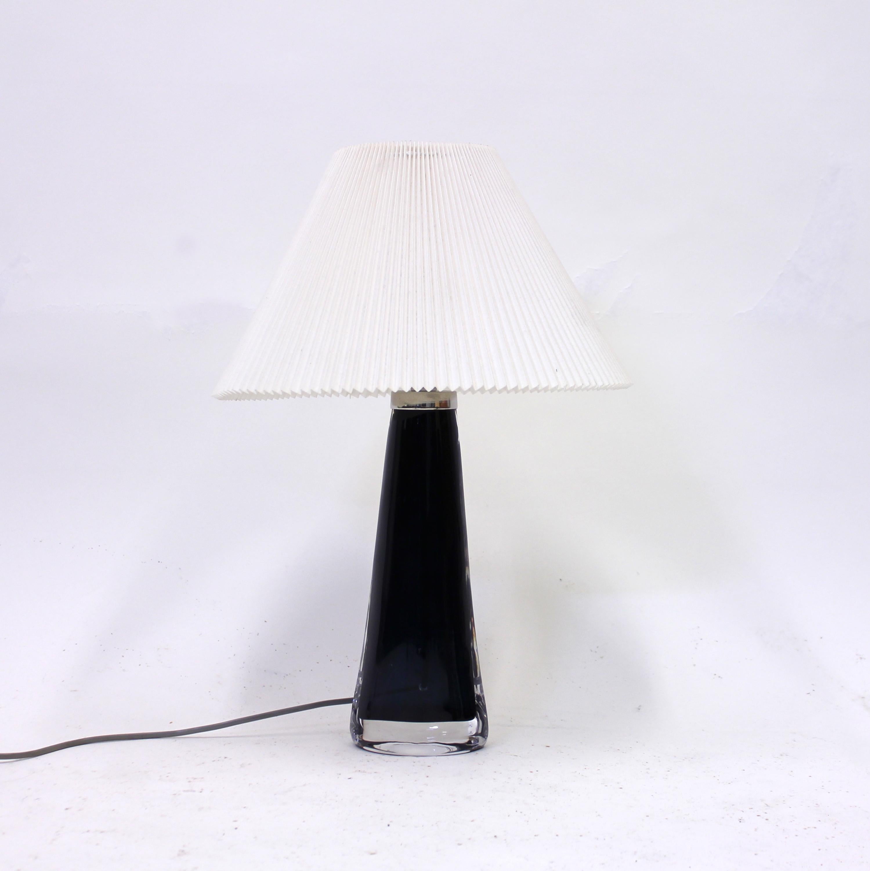 Blue glass table lamp designed by Carl Fagerlund for Swedish glass manufacturer Orrefors in the 1960s. Top of the base with chrome fitting and crimped white paper shade. Inscribed by Orrefors underneath. Good vintage condition with very ware