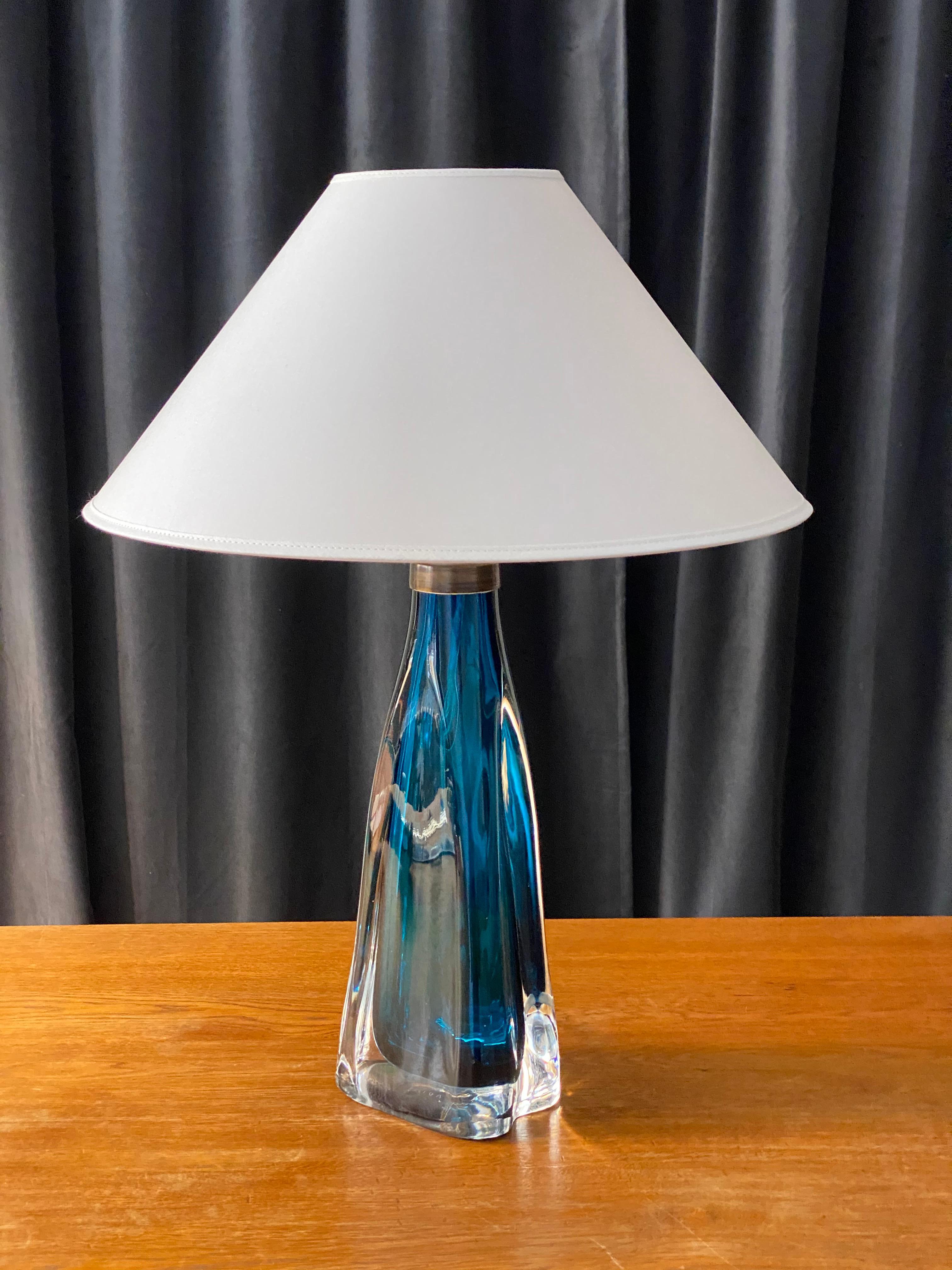 A sizable organic table lamp designed by Carl Fagerlund for Orrefors, where he served as a lighting designer from 1946-1980. Lamp is executed in lead glass. Partially blue-stained. Sold without lampshade.

In addition to product design for Orrefors