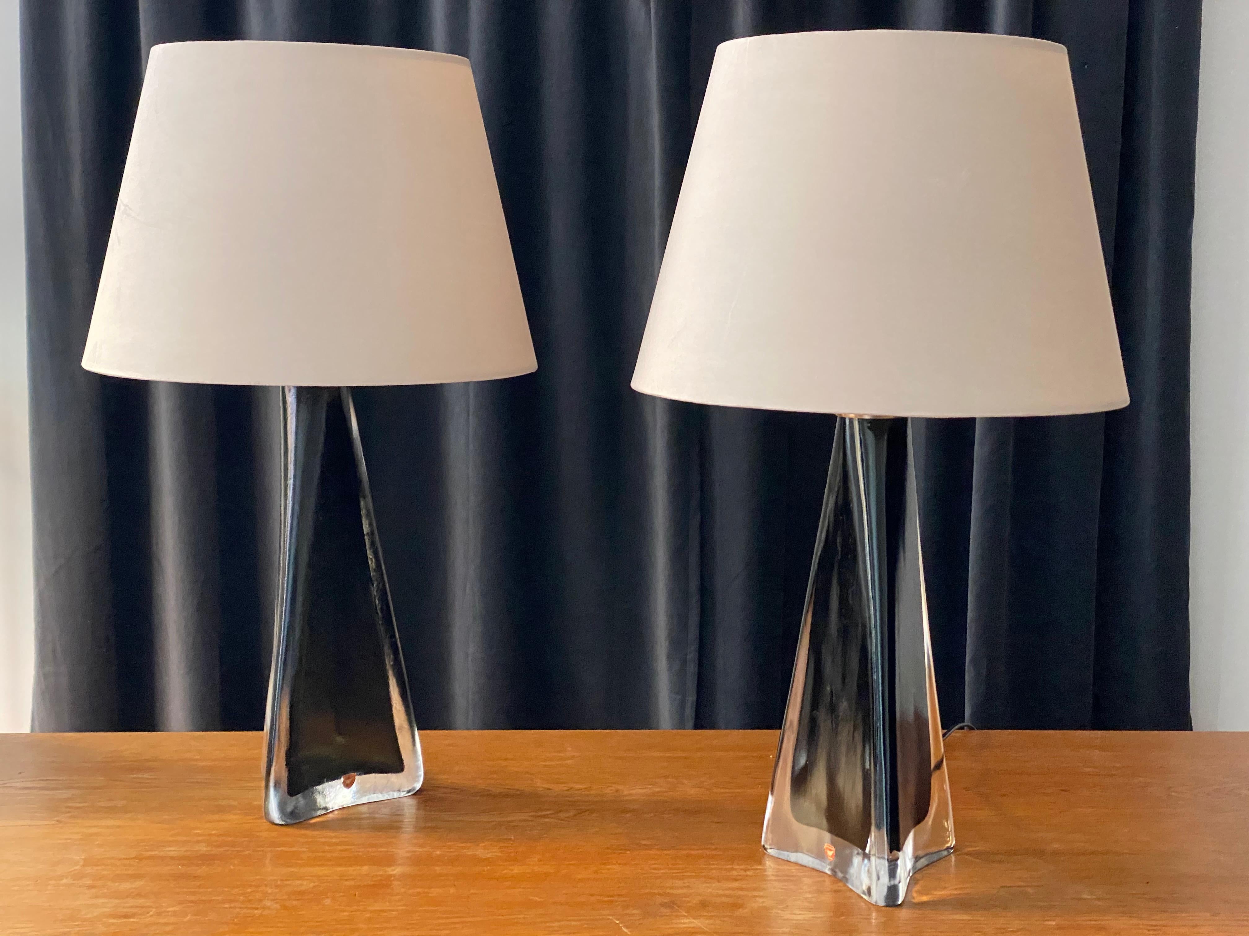 A pair of sizable table lamps designed by Carl Fagerlund for Orrefors, where he served as a lighting designer from 1946-1980. Label indicating the lamps are executed in lead glass. Partially black-stained. Sold without lampshades.

In addition to