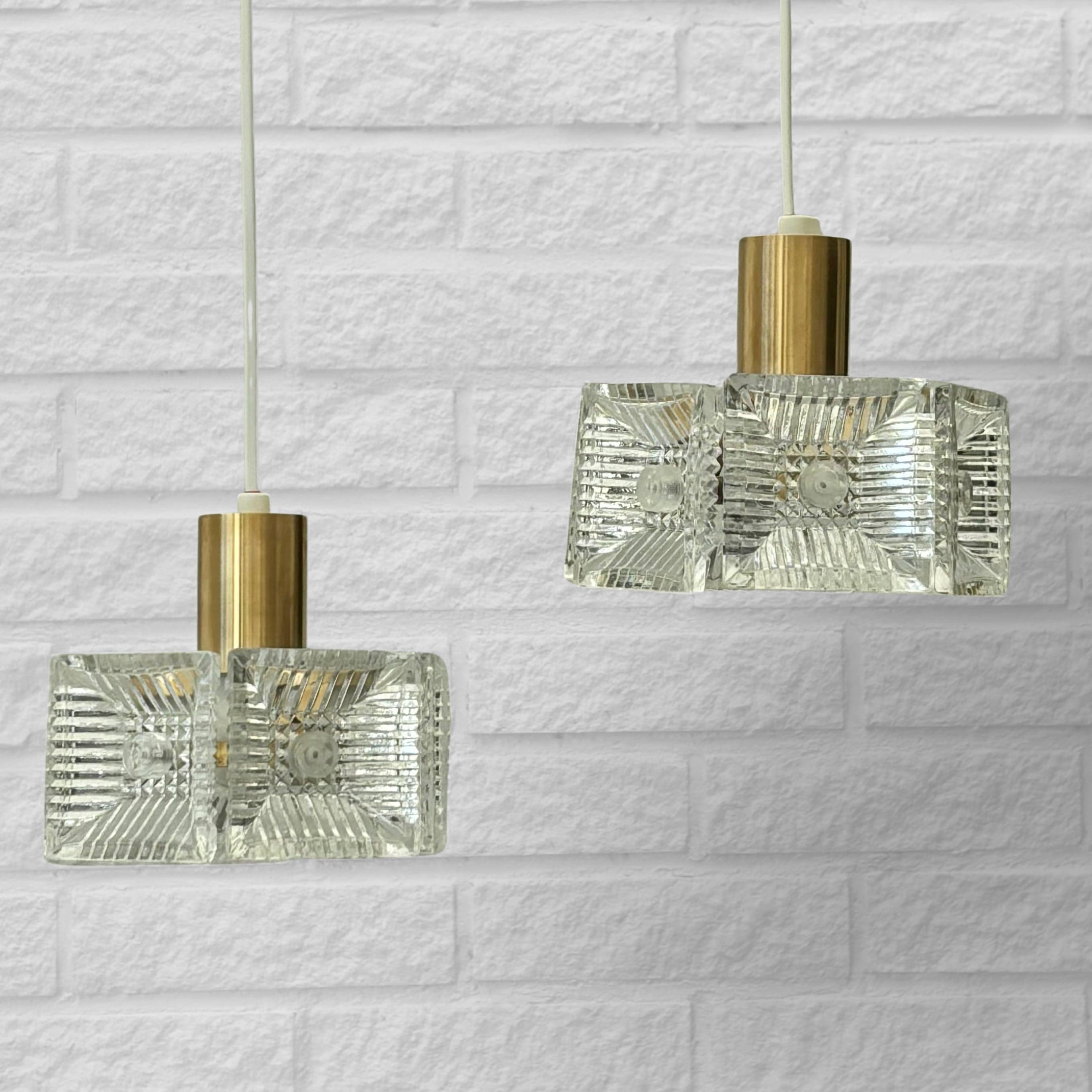 Swedish Carl Fagerlund, Orrefors, a pair of pendant lamps, brass & glass, Sweden, 1960s For Sale