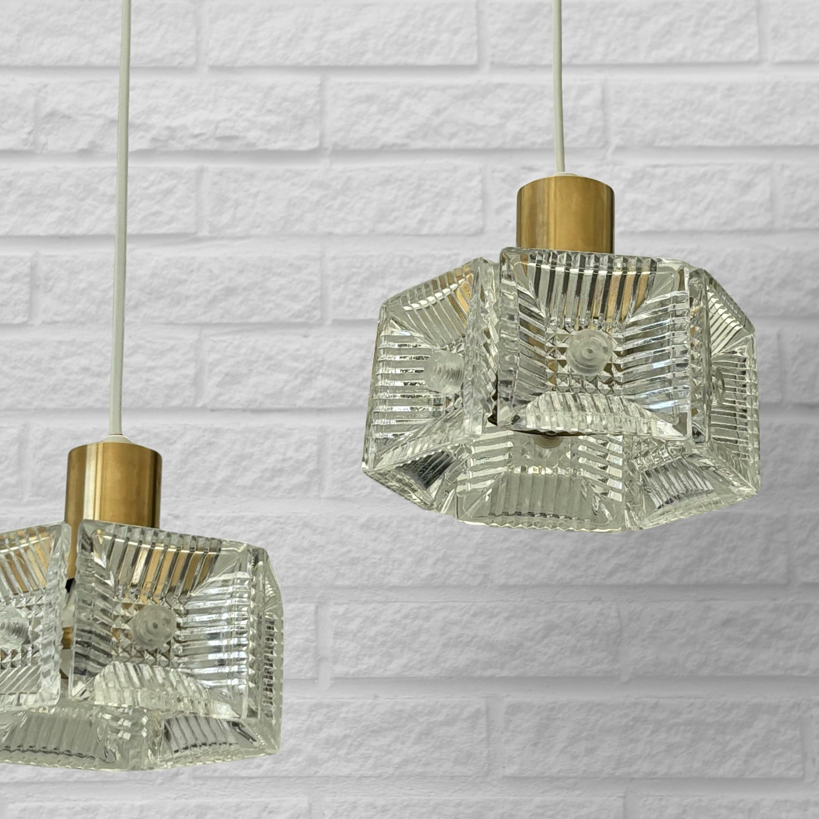Carl Fagerlund, Orrefors, a pair of pendant lamps, brass & glass, Sweden, 1960s In Good Condition For Sale In Forserum, SE