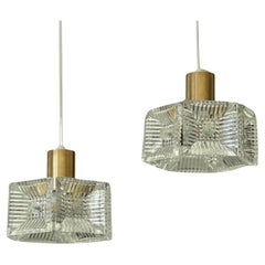 Carl Fagerlund, Orrefors, a pair of pendant lamps, brass & glass, Sweden, 1960s