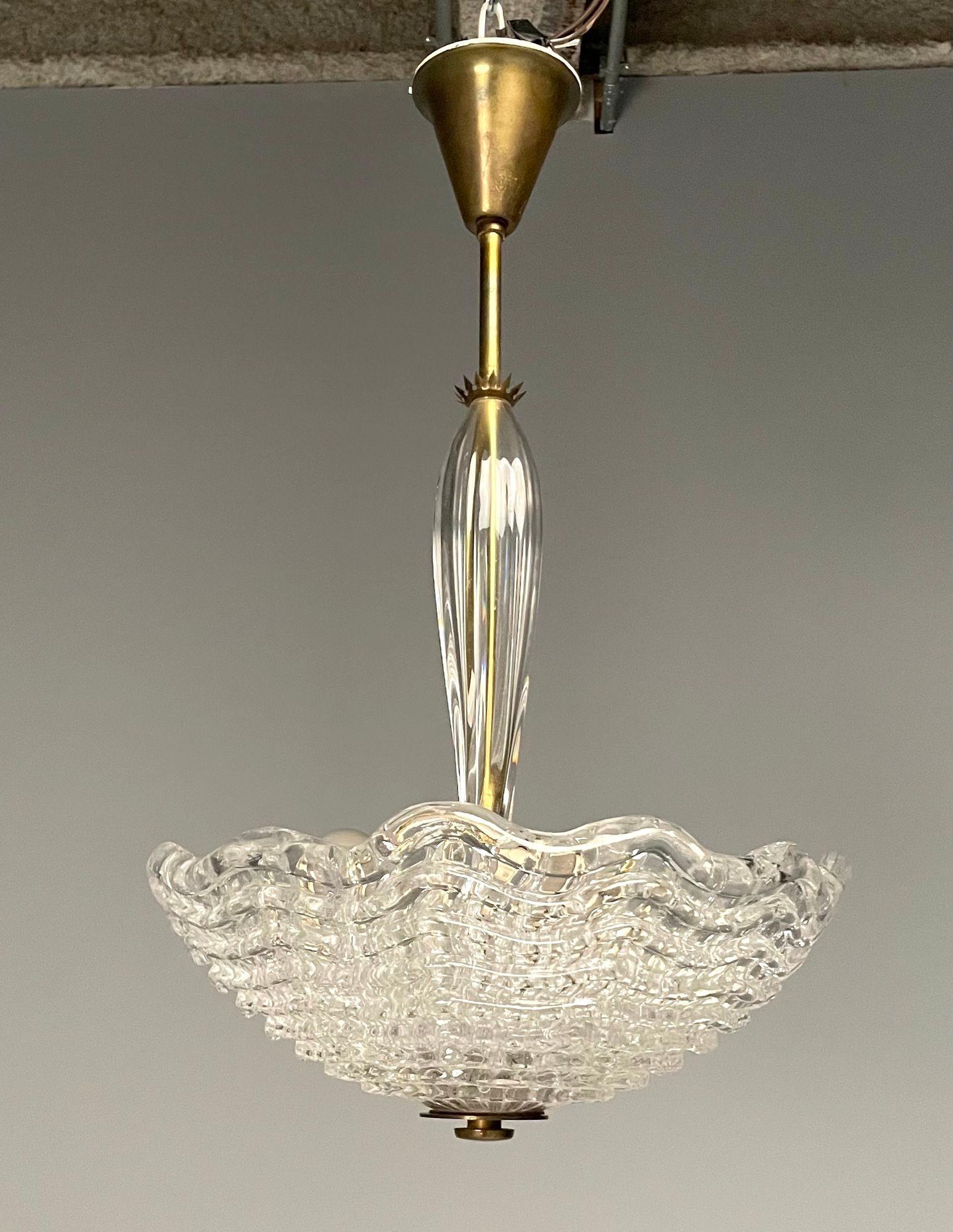 Carl Fagerlund, Orrefors, Swedish Mid-Century Modern, Chandelier, Glass, 1940s

Swedish modern chandelier or pendant designed by Carl Fagerlund for Orrefors in Sweden circa 1940s. This example features a brass stem fitted wtih a fluted glass table
