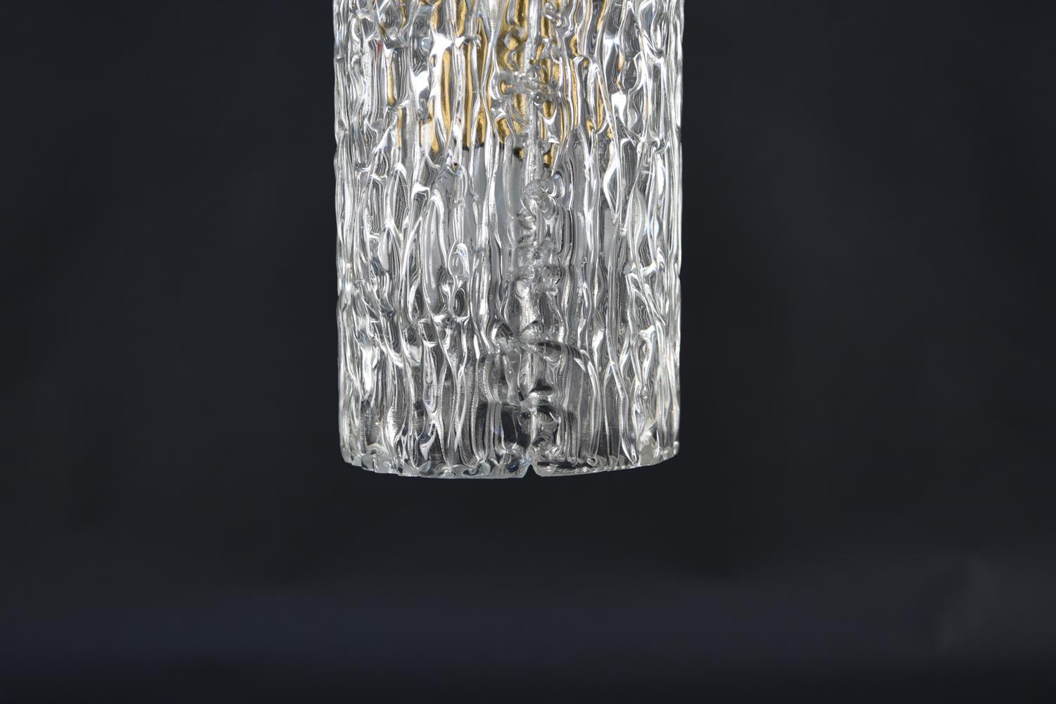 This midcentury petite textured glass pendant light was designed by the esteemed lighting designer Carl Fagerlund, who frequently worked with Swedish maker Orrefors. This piece is a beautiful way to brighten up a room. This pendant has been rewired