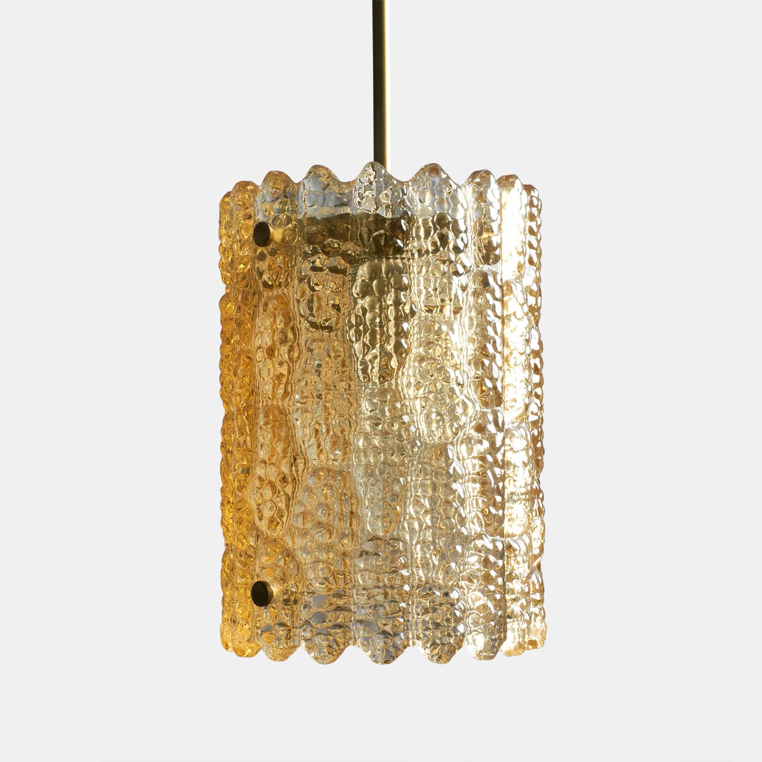 A pendant lamp of cast glass and brass by Carl Fagerlund for Orrefors. From their collection of lighting from the 1960s.