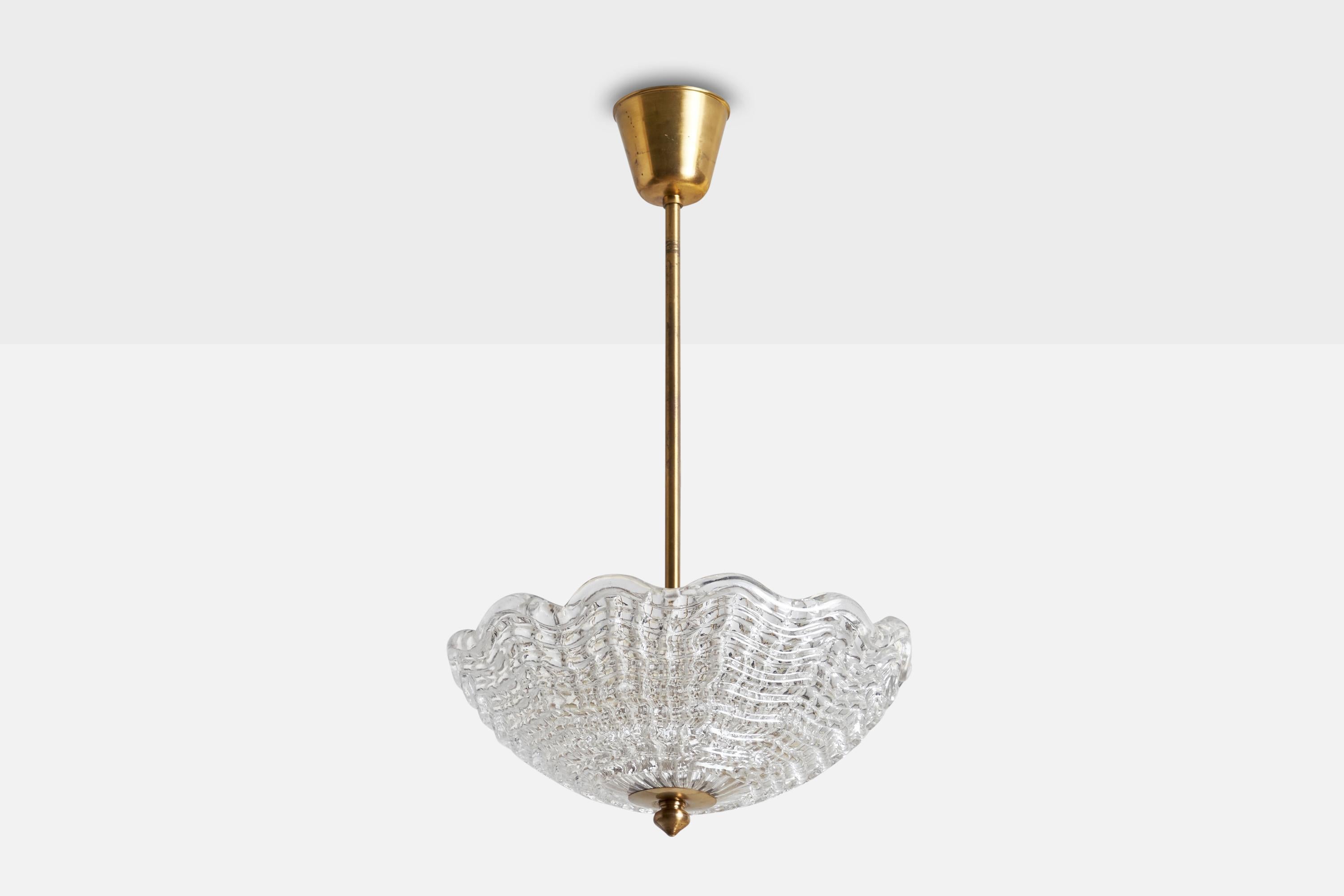 A brass and glass pendant light designed by Carl Fagerlund and produced by Orrefors, Sweden, c. 1950s.

Dimensions of canopy (inches): 3.25” H x 3.75” Diameter
Socket takes standard E-26 bulbs. 3 sockets.There is no maximum wattage stated on the