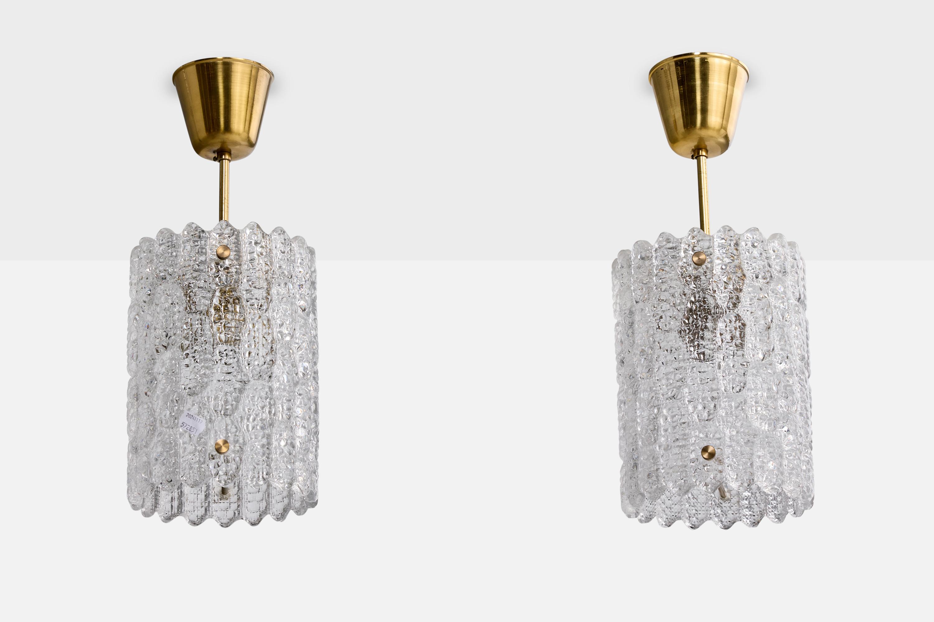 A pair of brass and glass pendant lights designed by Carl Fagerlund and produced by Orrefors, Sweden, c. 1960s.

Overall Dimensions (inches): 16.75