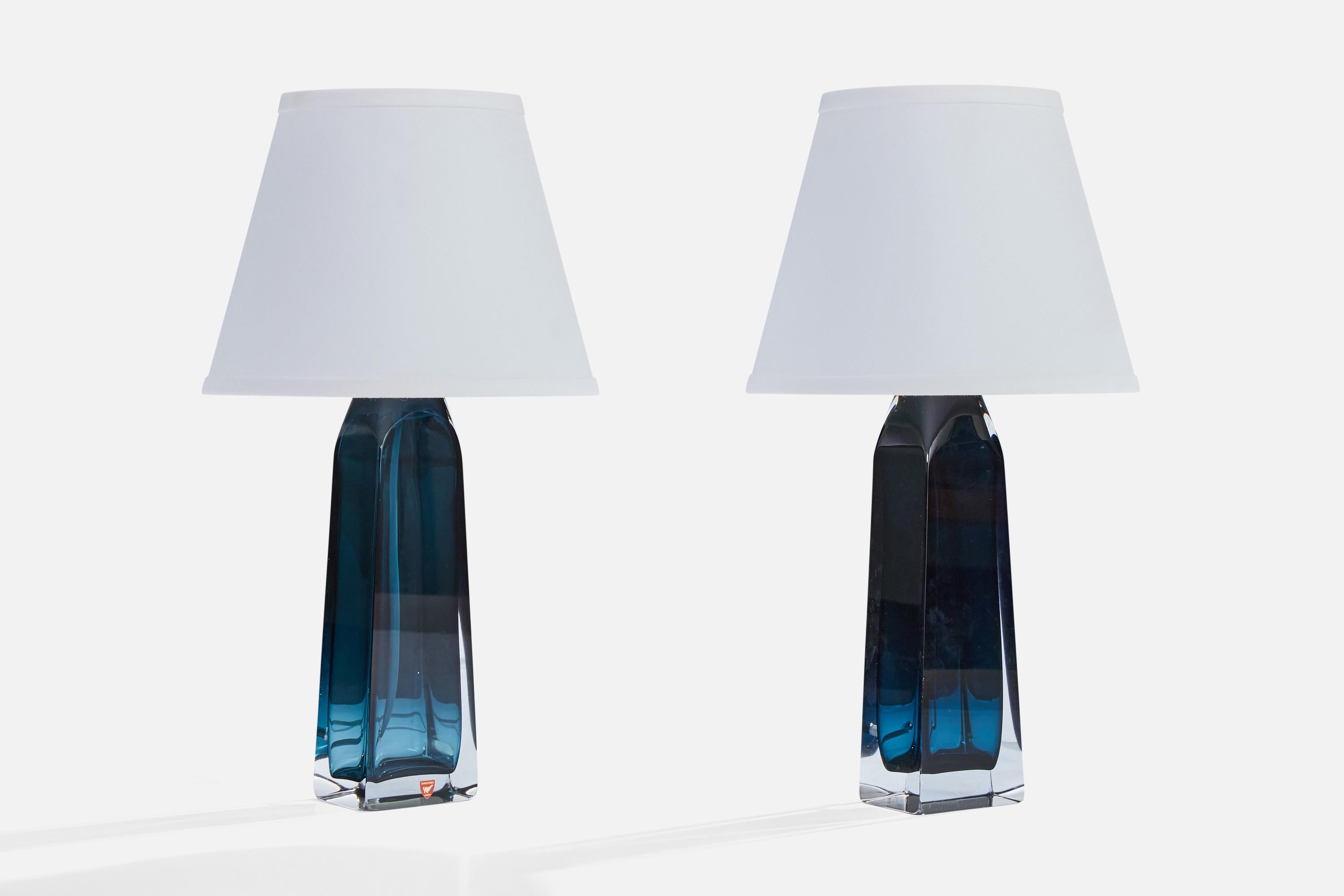 A pair of blue-colored crystal glass table lamps designed by Carl Fagerlund and produced by Orrefors, Sweden, c. 1960s.

Dimensions of Lamp (inches): 14.6