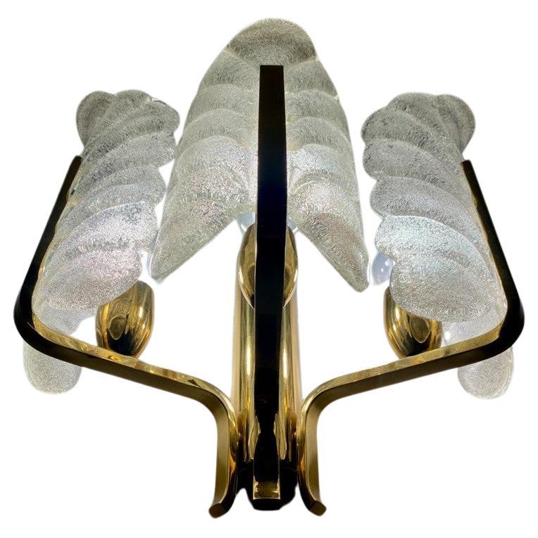 Stunning Murano glass wall lamp with brass fixture by Carl Fagerlund. The famous glass company Orrefors in Sweden is the manufacturer. The shades shimmer as you can see in the pictures and they are thick and heavy, real quality. The style is