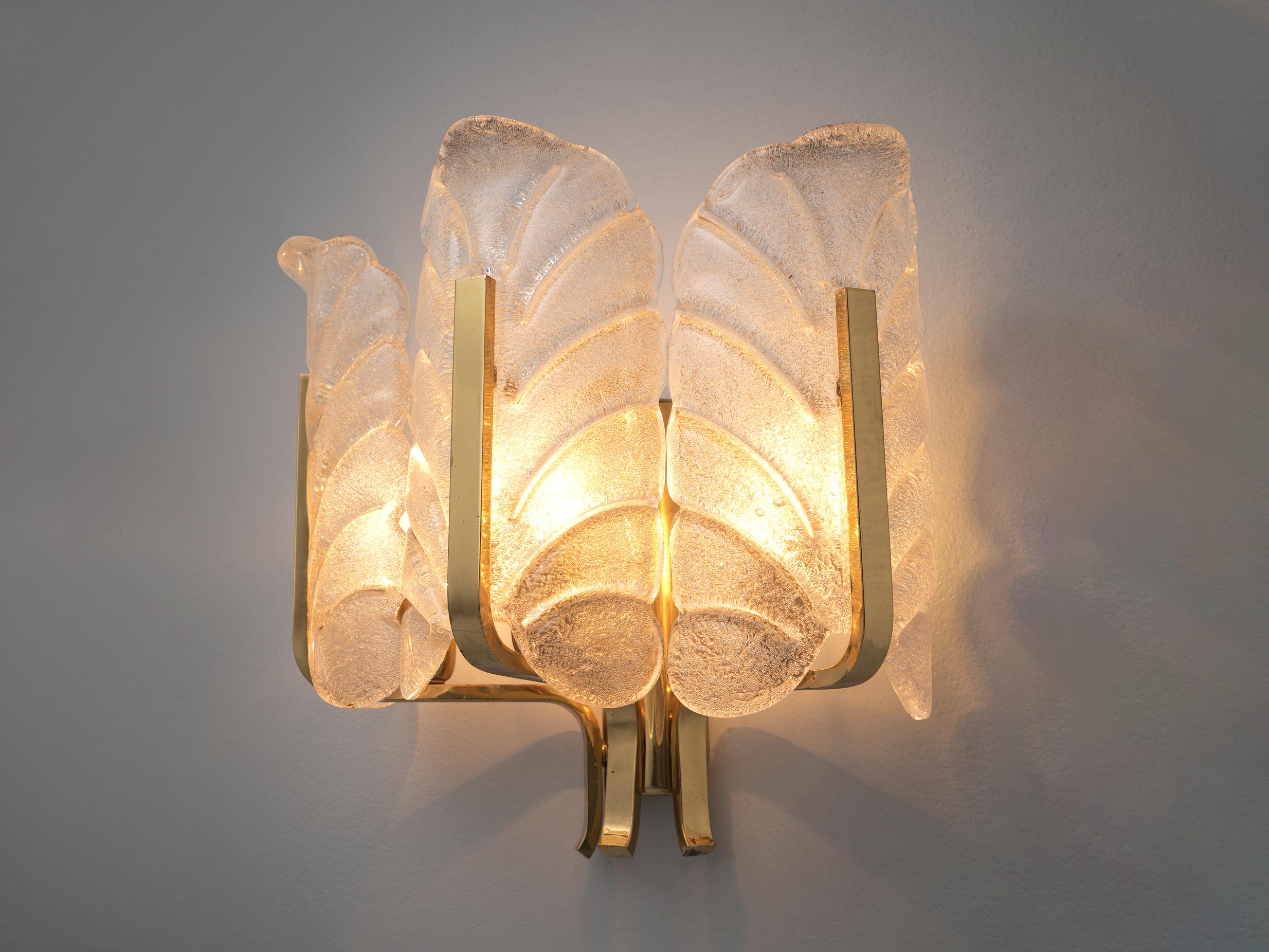 Carl Fagerlund, wall light, brass, glass, Europe, 1970s

Elegant wall sconce in structured Murano glass by Carl Fagerlund. This lamp consists of three glass shades, all shaped like a structured leaf. Due the structure of the glass and the brass