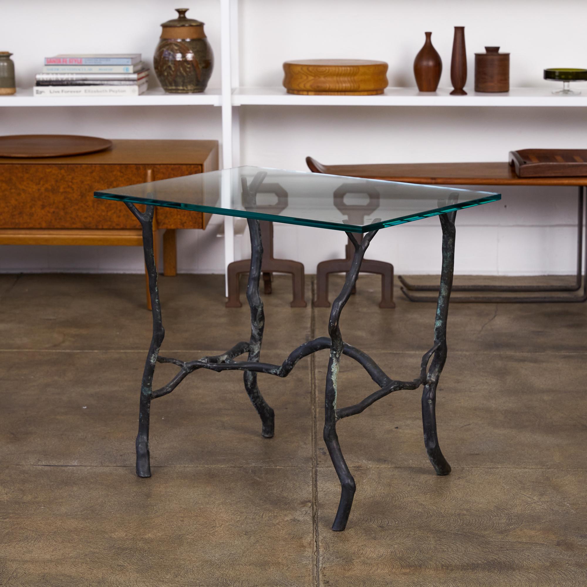 Bronze “Manzanita” side table by 20th century Malibu, CA artist and sculpture Carl Gillberg. The table features a solid patinated bronze base that is representative of tree branches, which holds up a thick piece of rectangular glass. Gillberg was a