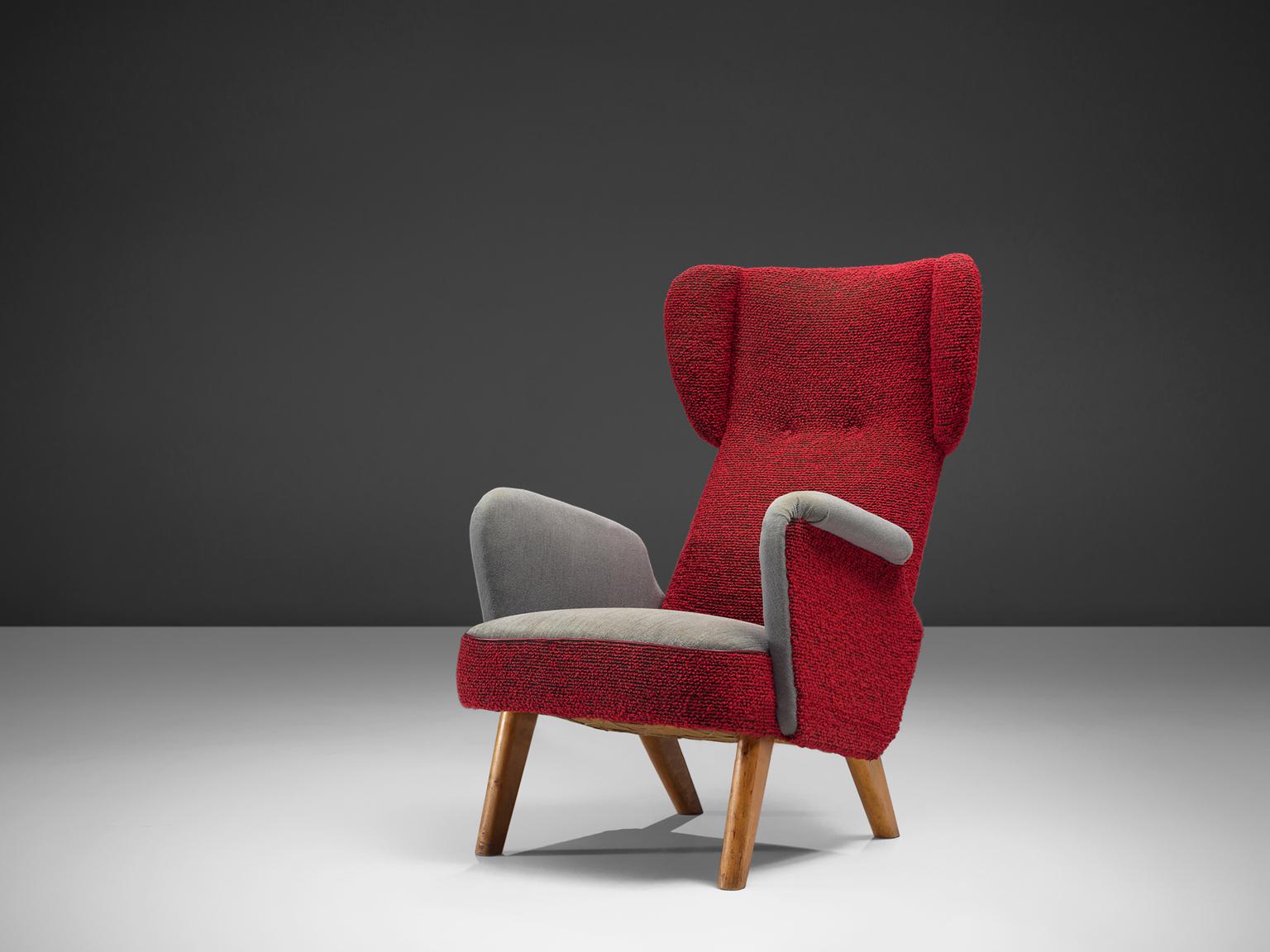 Carl Gustaf Hiort af Ornäs, lounge chair, fabric and oak, Finland, 1940s.

This sensuous wingback armchair has a curved back, little wings and tapered oak legs. The chair leans slightly backwards and has curved armrests, a buttoned back and is
