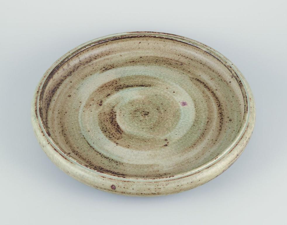 Pre-owned goods are exempt from import duties for U.S. customers. 
Therefore, no import tariffs will be applicable to your purchase.

Carl Halier (1873–1948) for Royal Copenhagen, large stoneware bowl.
Light 