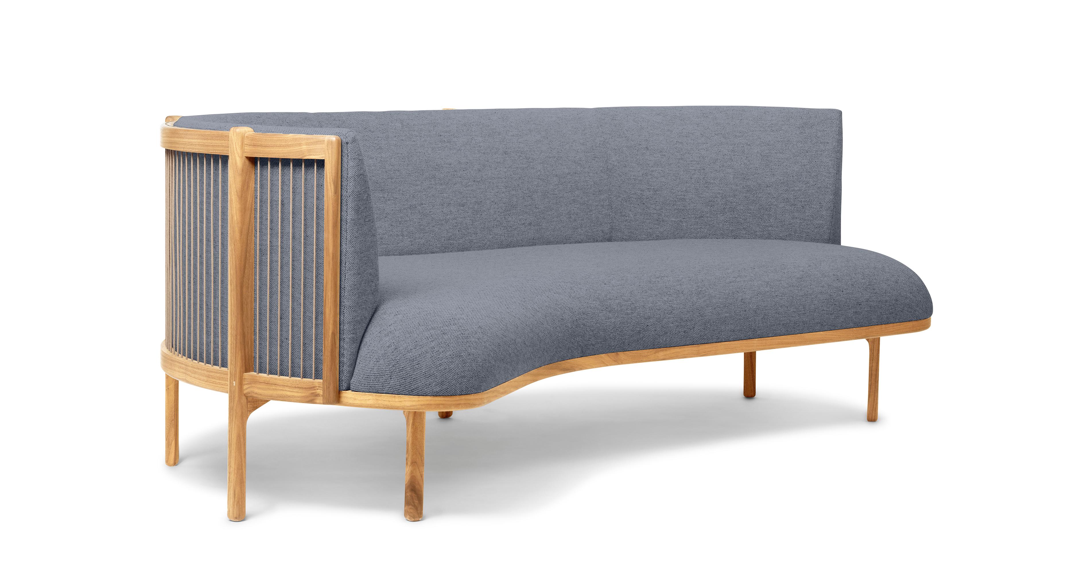 The Sideways sofa from Rikke Frost combines classic materials – wood, paper cord, and high-quality upholstery textile – with a modern asymmetric shape. The steam-bent backrest is shaped from solid wood and woven paper cord for a light, elegant
