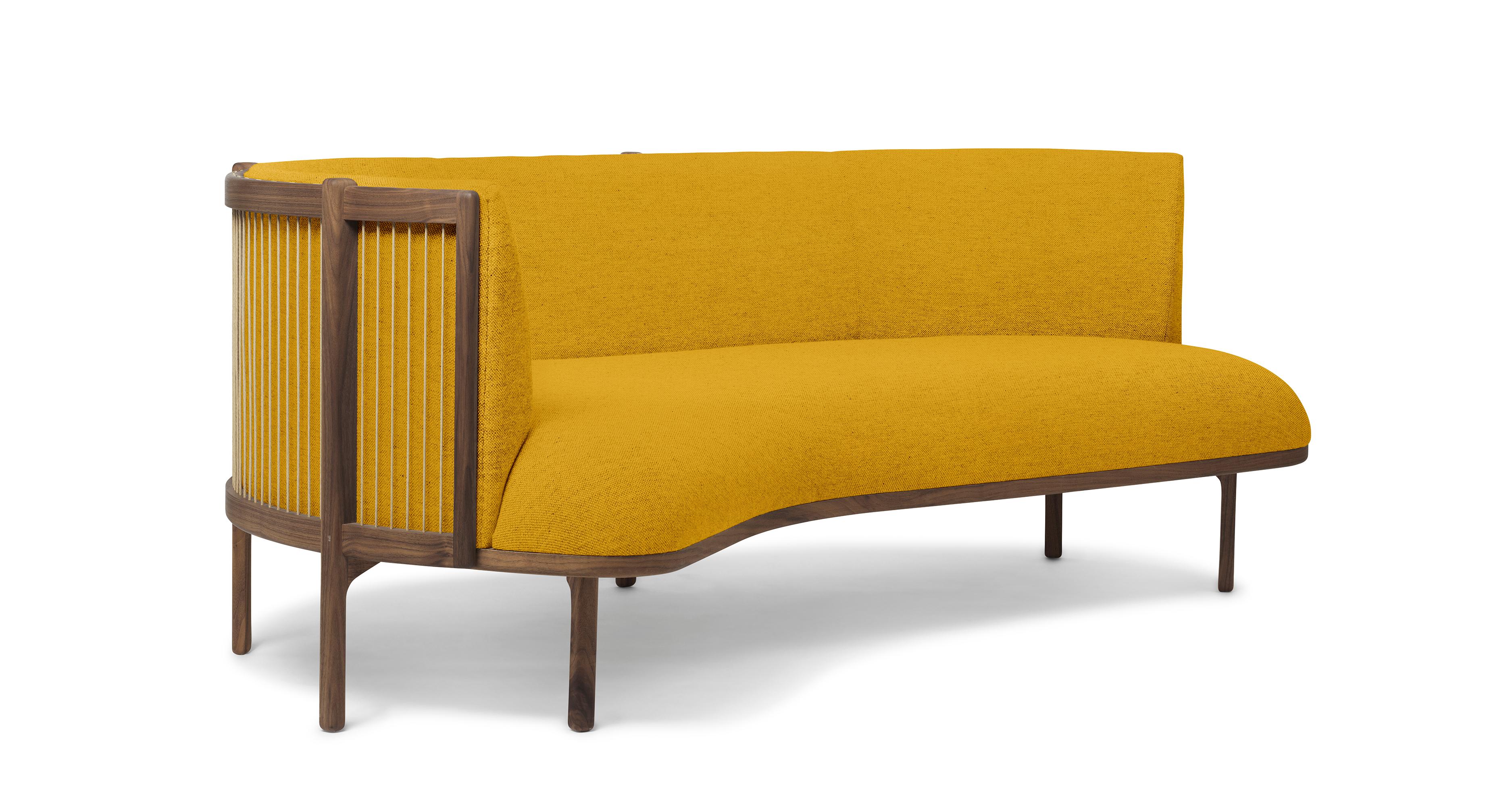 The sideways sofa from Rikke Frost combines Classic materials - wood, paper cord, and high-quality upholstery textile - with a modern asymmetric shape. The steam-bent backrest is shaped from solid wood and woven paper cord for a light, elegant