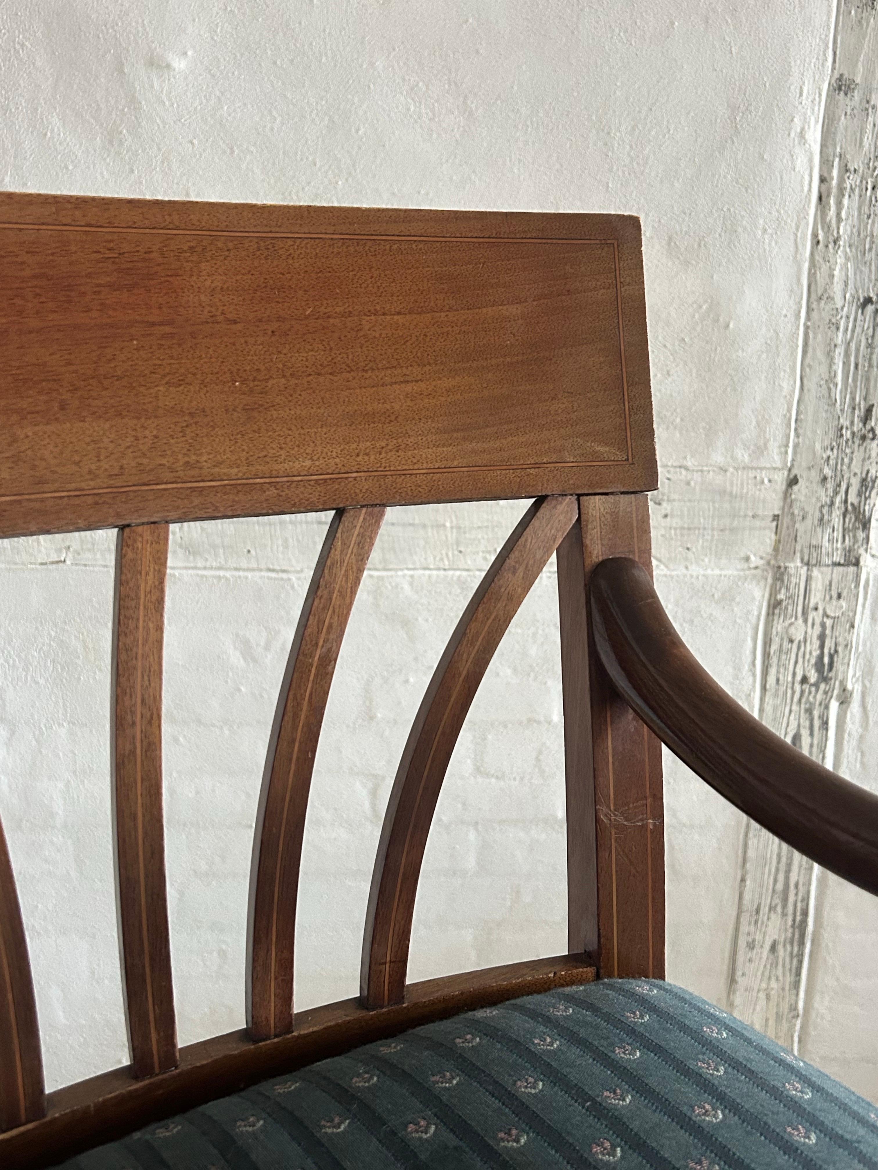 Rare pair of armchairs by the Danish architect Carl Harald Brummer, crafted in solid mahogany with fine intarsia details, bronze shoes, and upholstered seats and backs. The chairs exemplify Brummer’s refined architectural sensibility — a synthesis