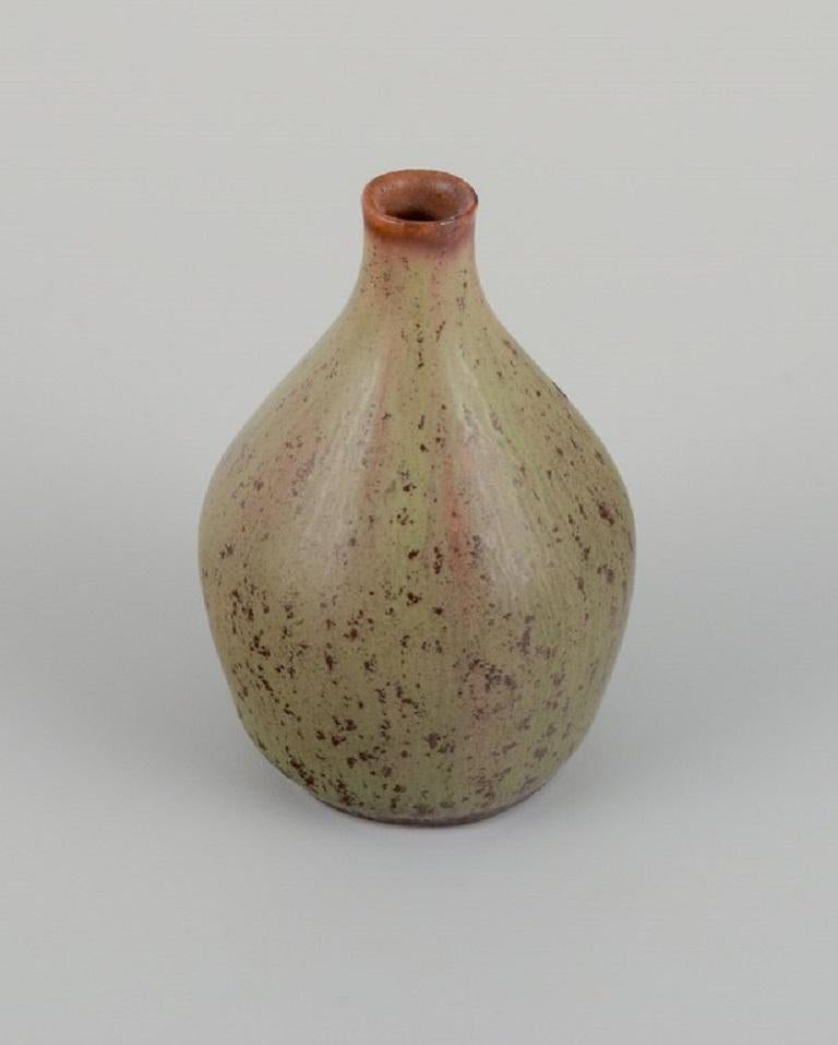 Carl Harry Ståhlane (1920-1990) for Rörstrand.
Miniature vase with mottled glaze in earth tones.
Mid-20th Century.
In perfect condition.
Dimensions: D 3.5 x H 5.2 cm.