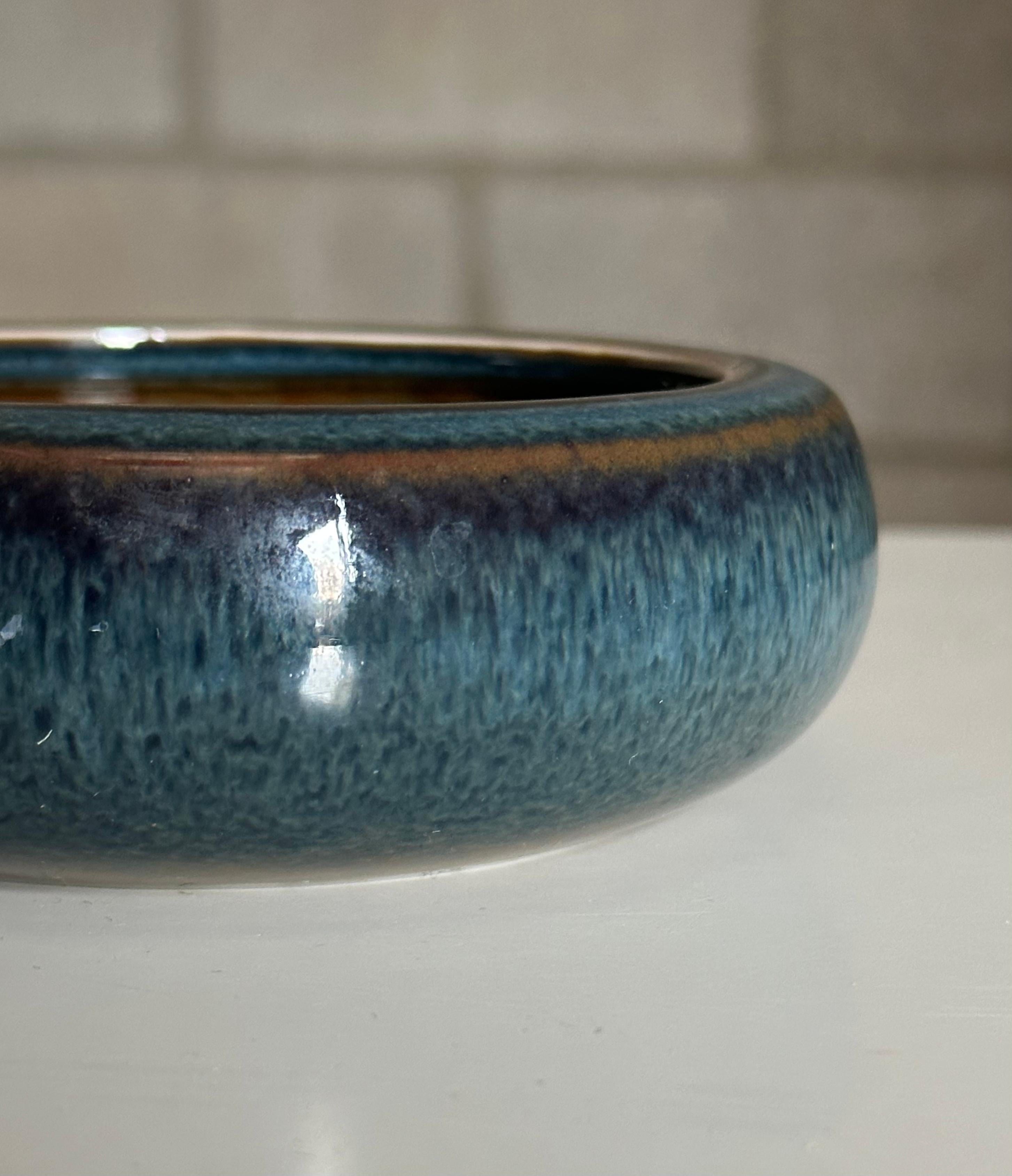 A gorgeous bowl in an unusual glossy blue glaze by Carl Harry Stålhane for Rörstrand. Good size could allow for use as a vide poche. Would work well in a variety of interiors from modern, mid century modern contemporary, minimalist, Swedish modern,