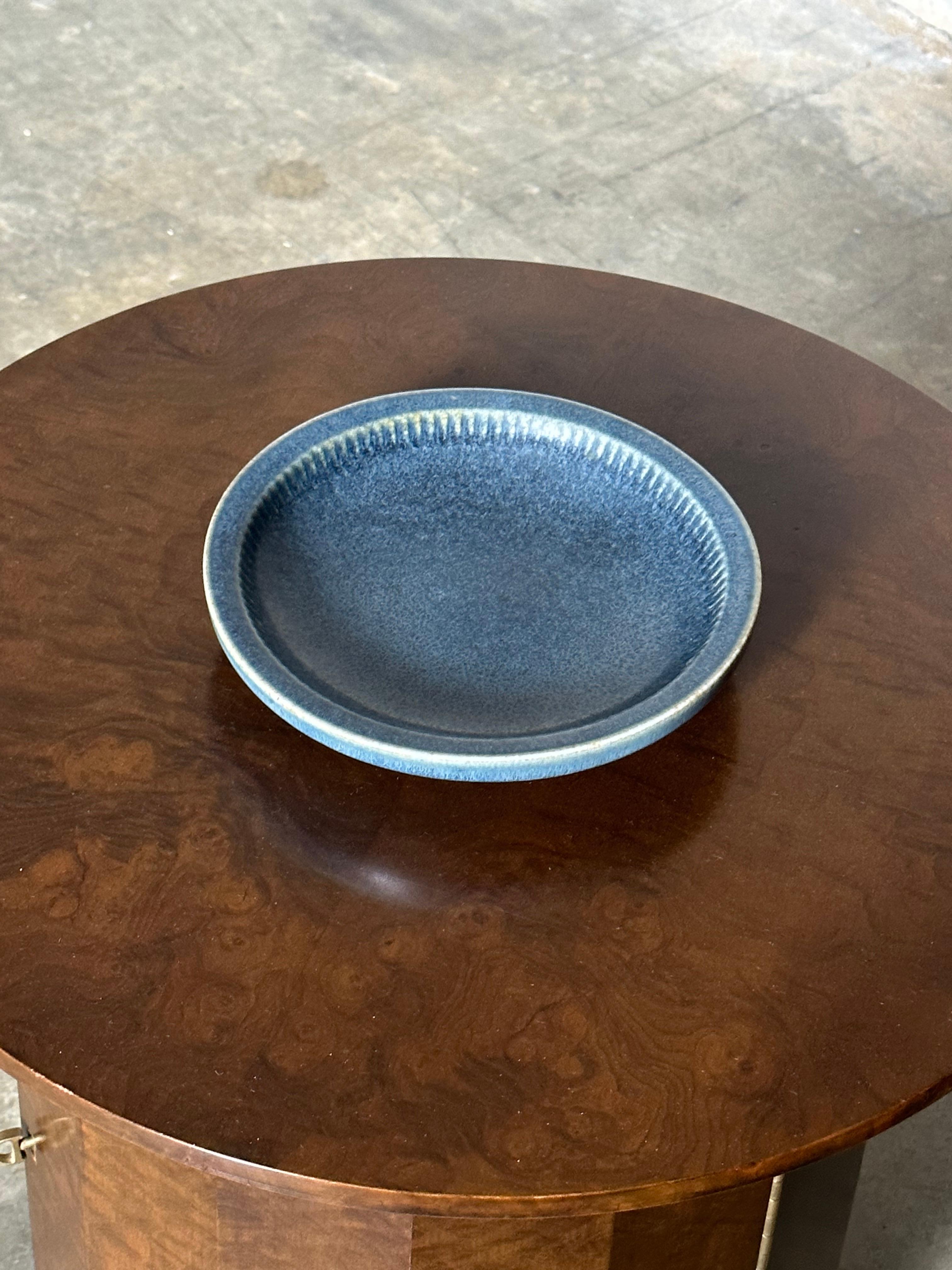 A unique bowl designed by Carl Harry Stålhane for Rörstrand. Bowl features a unique baby blue color palette with details around interior edge giving an almost ribbed like appearance. Very heavy and well sized piece.