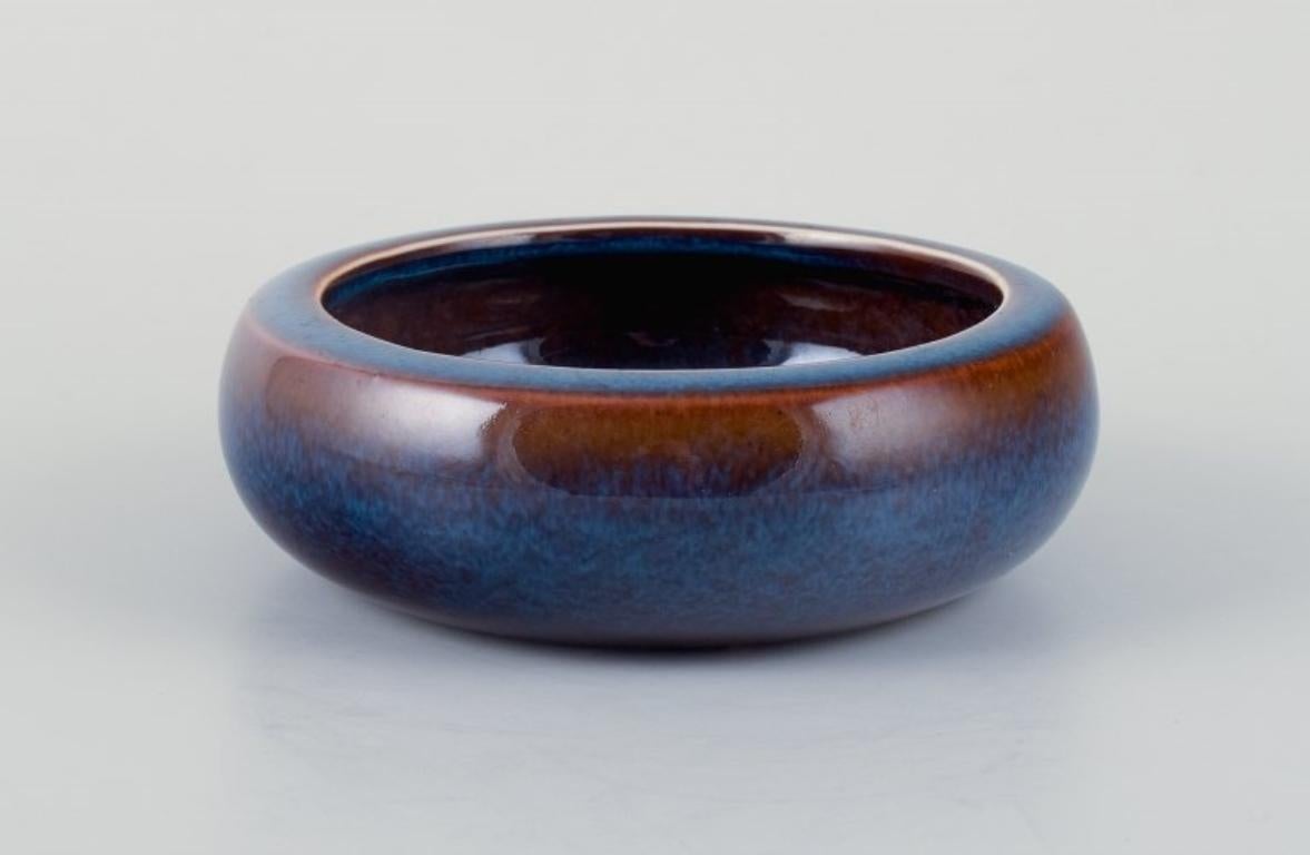 Carl Harry Stålhane for Rörstrand.
Ceramic bowl with glaze in blue-brown shades.
Mid-20th century.
In perfect condition.
First factory quality.
Marked.
Dimensions: D 12.0 cm x H 4.0 cm.