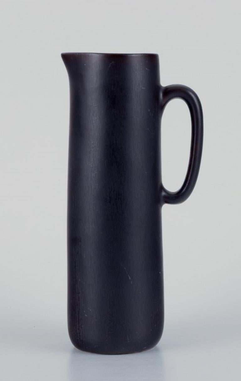 Scandinavian Modern Carl Harry Stålhane for Rörstrand. Ceramic jug with glaze in dark brown shades.  For Sale