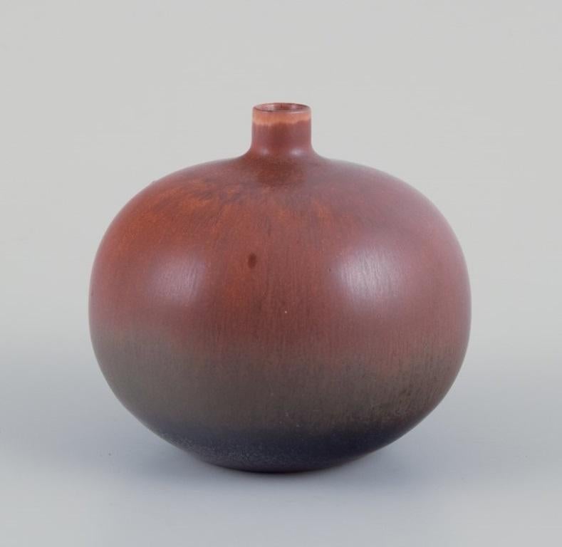 Carl Harry Stålhane (1920-1990) for Rörstrand, Sweden. 
Vase with a round shape and a small neck. Brown-toned glaze.
Mid-20th century.
Marked.
In perfect condition.
First factory quality.
Dimensions: D 7.0 cm x H 7.0 cm.

Carl-Harry Stålhane is