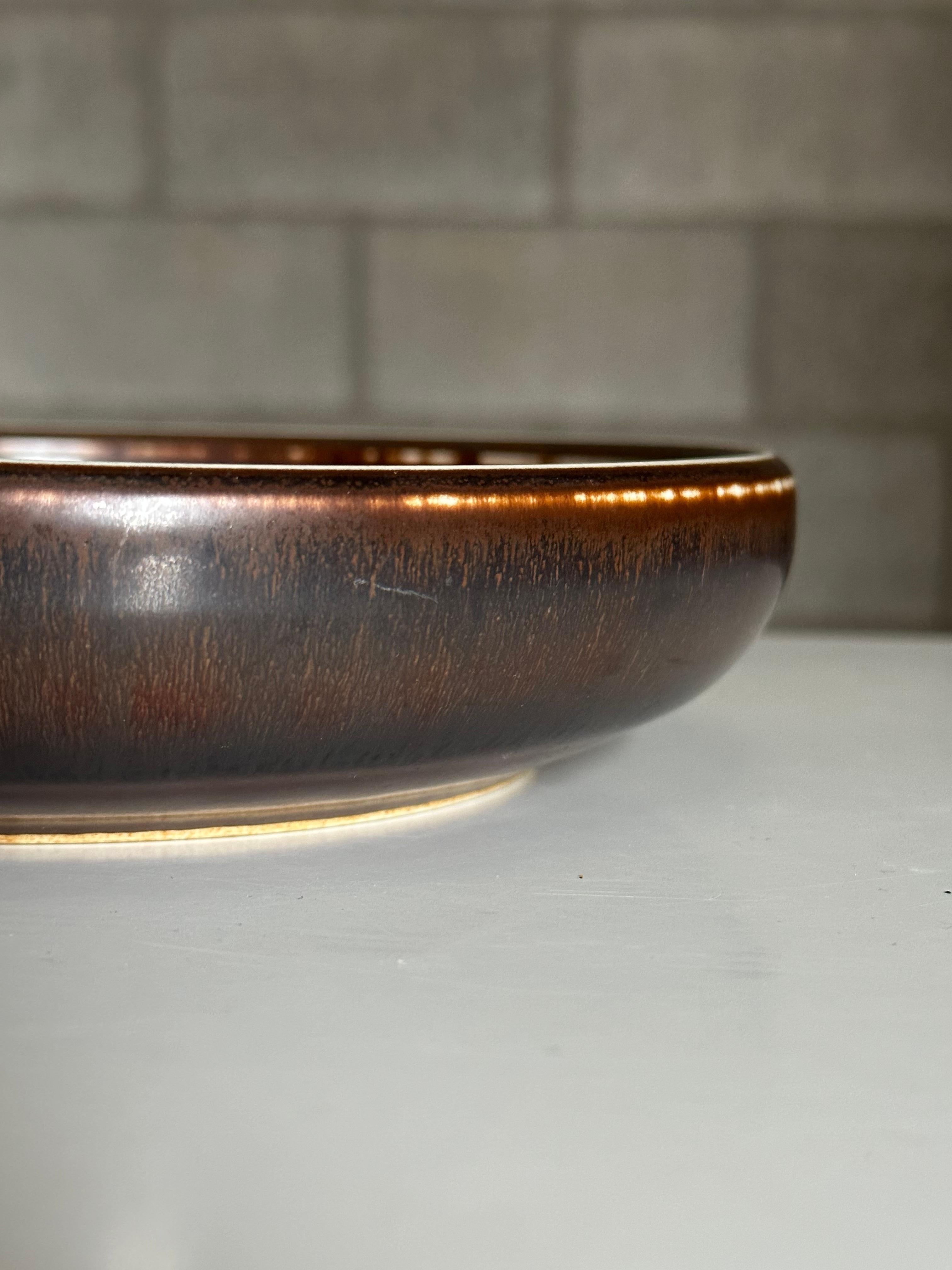 A sizable low bowl designed by Carl Harry Stålhane for Rörstrand. Would work well in a variety of applications including as a small fruit bowl, as a catchall, ashtray, etc. Really nice colors and scale, gives it a good presence.