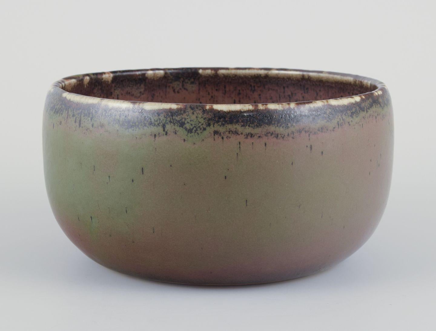 Pre-owned goods are exempt from import duties for U.S. customers. 
Therefore, no import tariffs will be applicable to your purchase.

Carl Harry Stålhane (1920-1990) for Rörstrand, Sweden.
Large ceramic bowl.
Glaze in shades of brown and