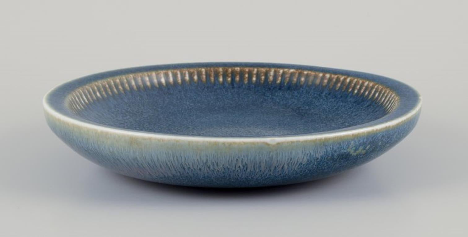 Carl Harry Stålhane (1920-1990) for Rörstrand, Sweden.
Large ceramic bowl. Glazed in blue shades.
Mid-20th century.
Stamped.
In excellent condition.
Second factory quality.
Dimensions: D 23.0 cm x H 4.4 cm.