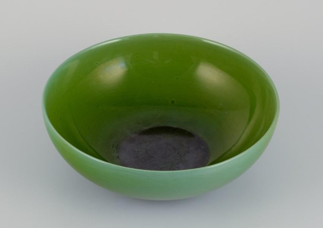 Carl Harry Stålhane (1920-1990) for Rörstrand, Sweden. 
Large ceramic bowl in apple green glaze.
Mid-20th century.
Marked.
In excellent condition with natural cracks.
Second factory quality.
Dimensions: Diameter 26.0 cm x Height 9.0 cm.