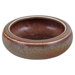 Carl Harry Stålhane for Rörstrand. Low ceramic bowl with brown and green glaze.
