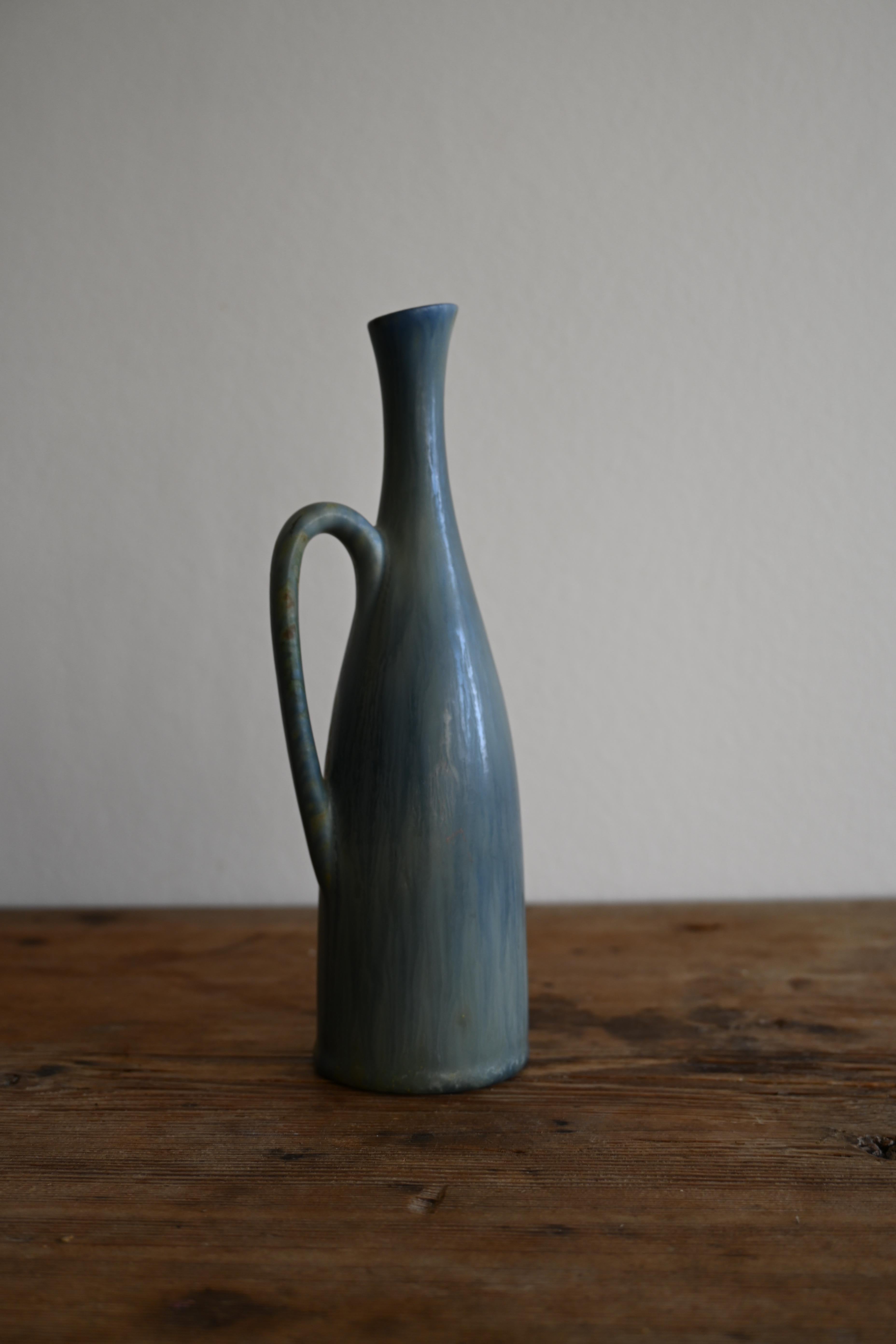 Carl Harry Stålhane for Rörstrand Midcentury Vase 1950s Sweden

The mid-century vase from the 1950s by Carl Harry Stålhane for Rörstrand, Sweden, features an alluring blue glaze, adding a touch of captivating color to the timeless design and