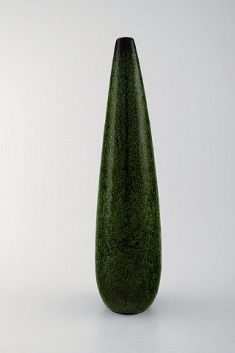 Carl-Harry Stålhane for Rorstrand/Rørstrand, large ceramic vase.
Glaze in green shades.
Measures 29 x 8 cm.
In perfect condition. 1st. factory quality.