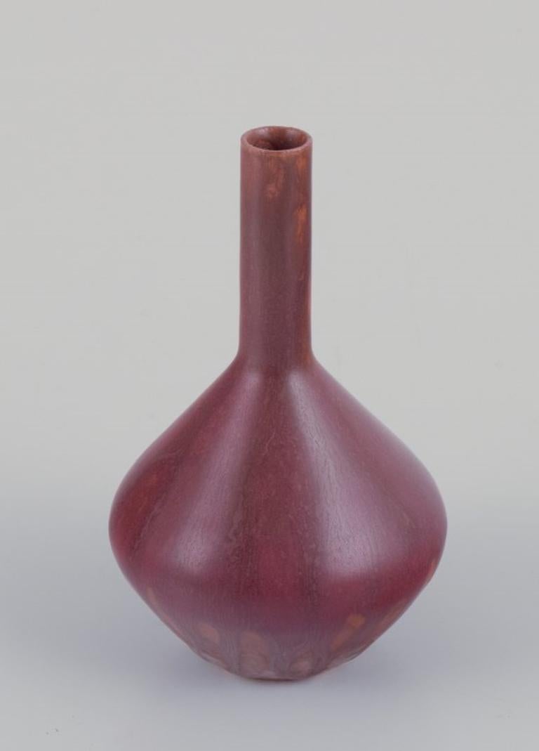Carl Harry Stålhane (1920-1990) for Rörstrand, Sweden. 
Ceramic vase with a slender neck. Brown-toned glaze.
Mid-20th century.
Marked.
In perfect condition.
First factory quality.
Dimensions: H 10.0 cm x D 6.5 cm.

Carl-Harry Stålhane is widely