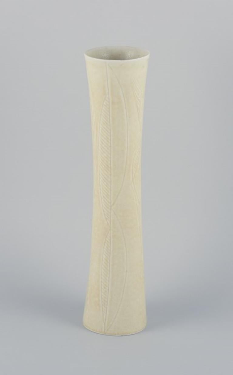 Carl Harry Stålhane for Rörstrand. Tall and slender ceramic vase decorated with geometric pattern and cream-colored glaze.
Mid-20th century.
Marked.
In good condition, with a minimal and insignificant chip inside the top of the vase.
Second factory