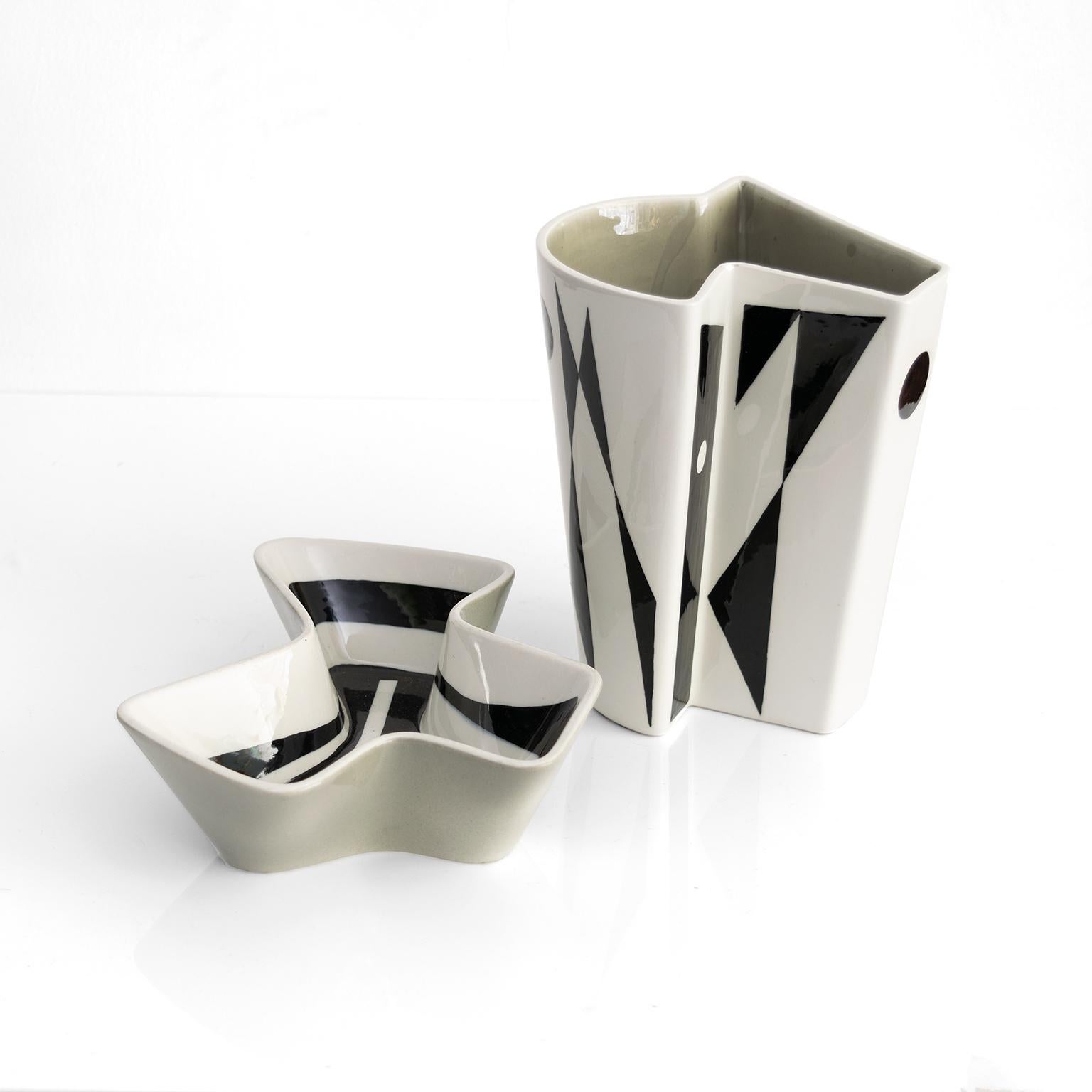 Carl- Harry Stalhane ceramic vase and bowl in angular free-form shapes. Decorated brilliantly with black designs on white and pale gray glazes. Made at Rorstrand, Sweden 1950

Vase: Height 8”, Width: 6”, Depth: 5”

Bowl: Height: 2.25“ Length: 9“