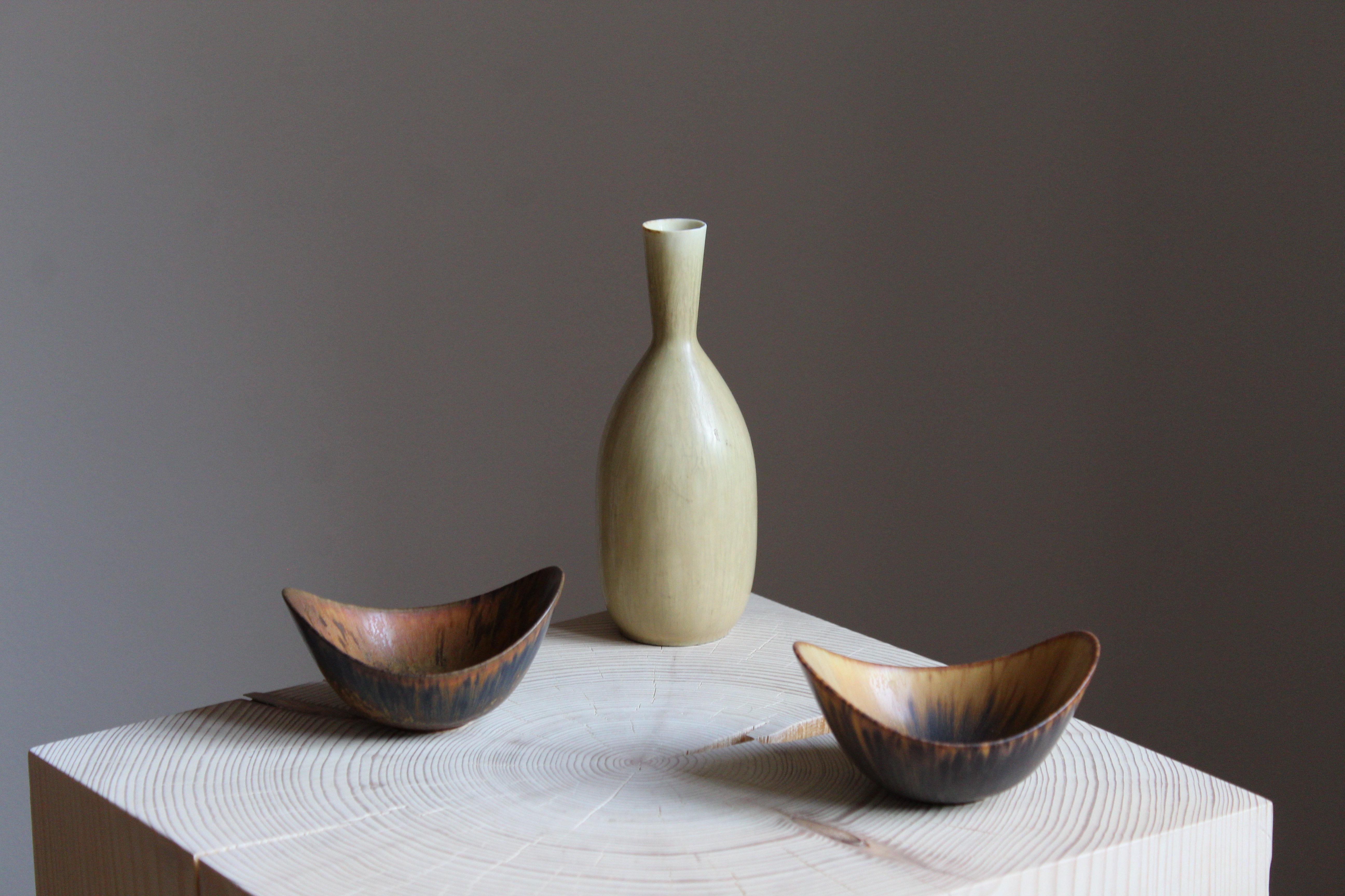 An assorted collection of small 1 vase and small 2 bowls executed in stoneware and produced by Rörstrands, Sweden, 1940s. The vase and one bowl are factory seconds.


Has a similar style as works by ceramicists such as Axel Salto, Carl-Harry
